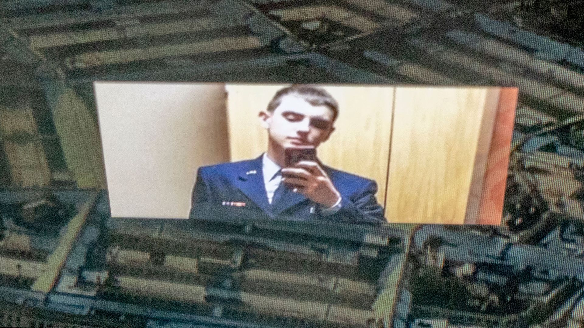 Image of Jack Teixeira reflected in an image of the Pentagon