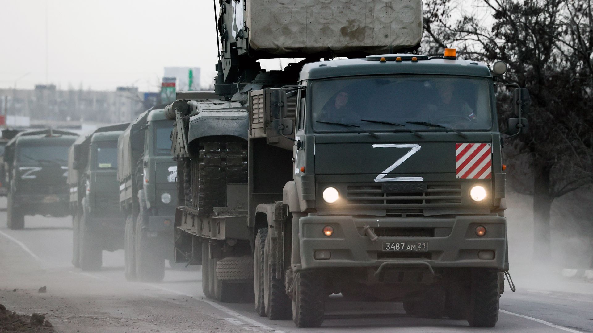 A column of army trucks moves across the town of Armyansk, northern Crimea. Early on February 24.