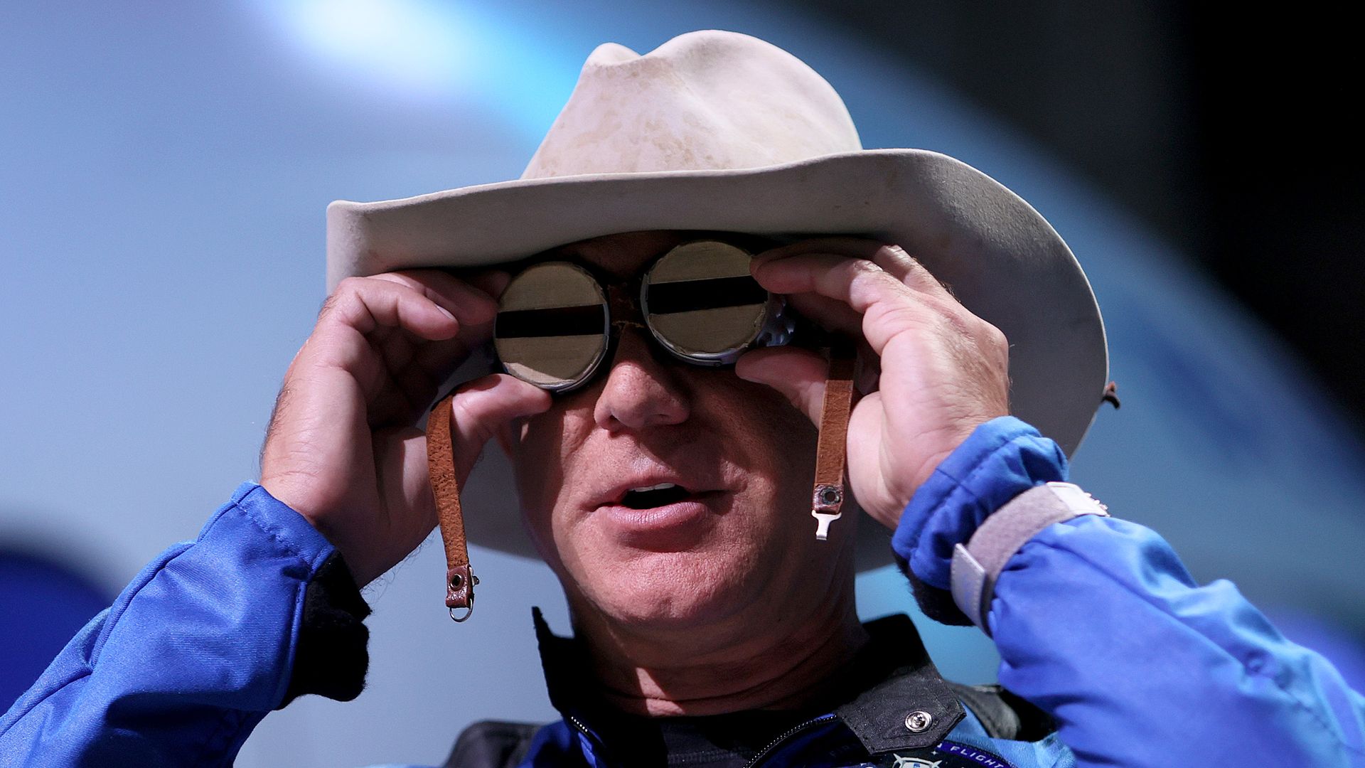Jeff Bezos holding the aviation glasses that belonged to Amelia Earhart during a press conference in July 2021.