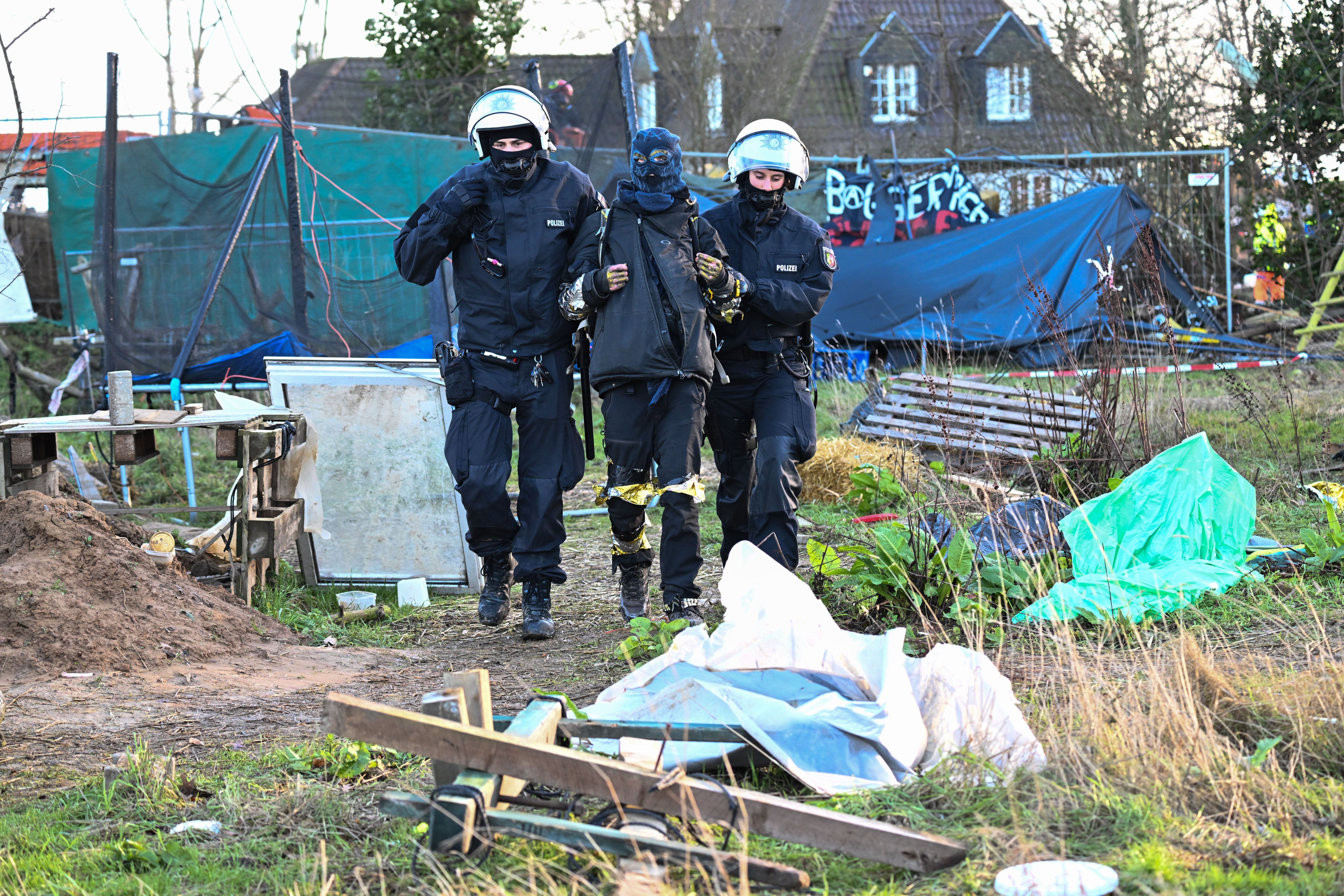 Police officers lead a climate activist off the site in Lützerath, Germany, Jan. 15.