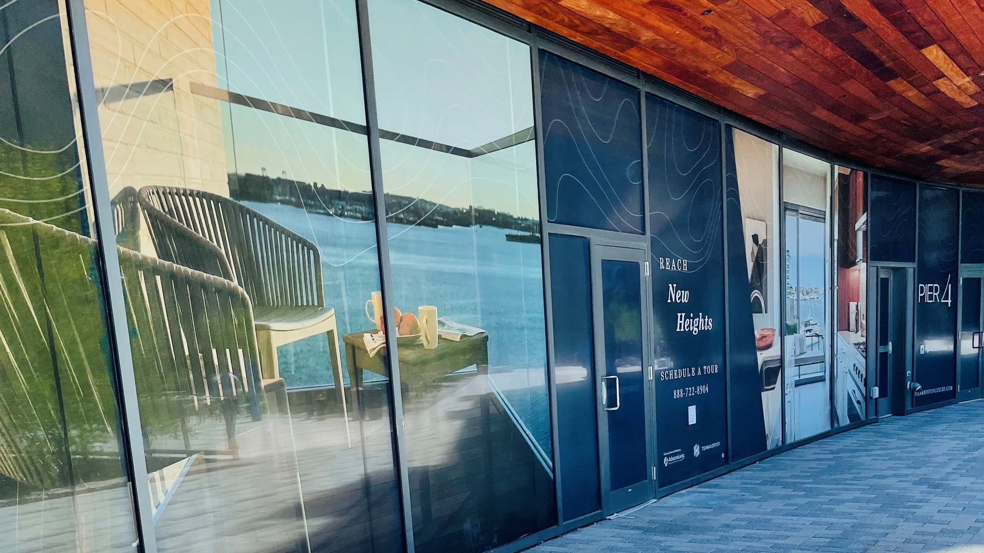 The storefront where East End Books will open later this year is covered up with advertising print.