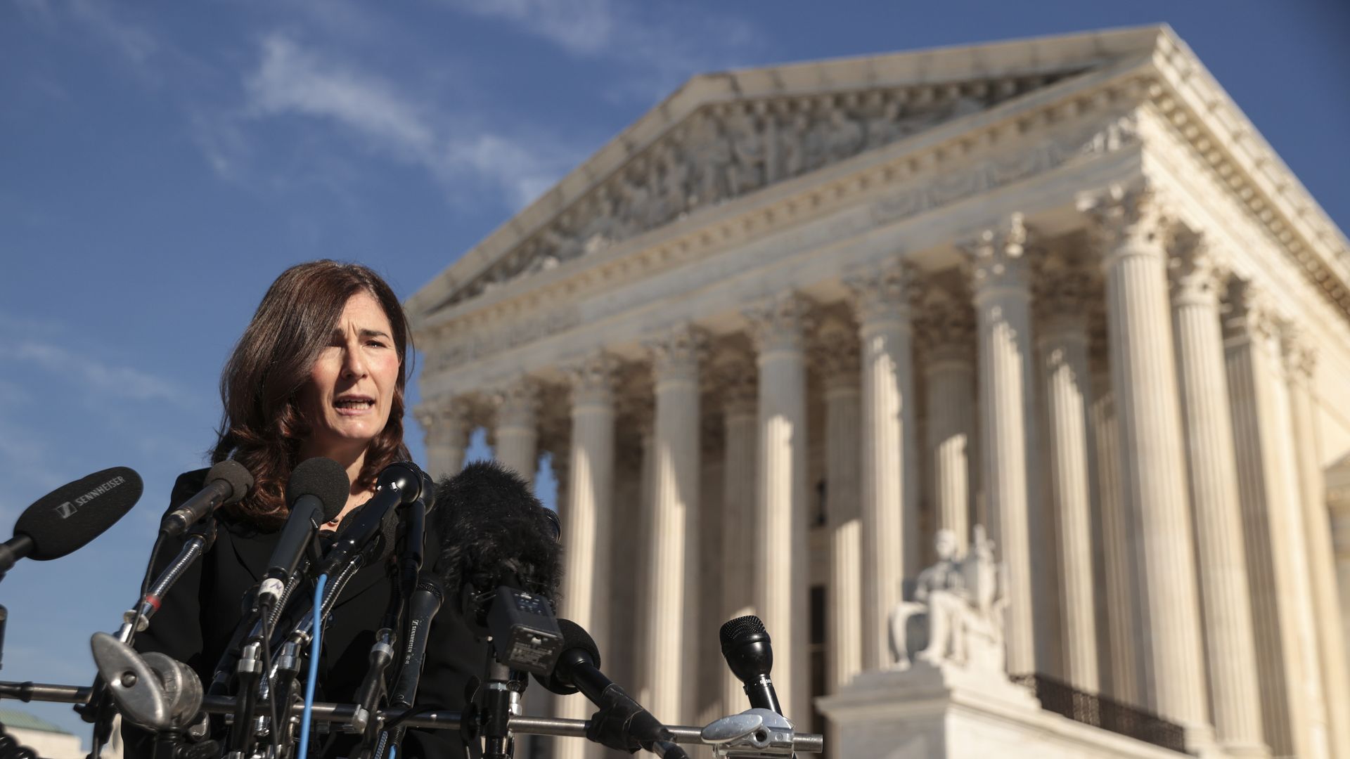 Picture of Julie Rikelman standing in front of the Supreme Court building