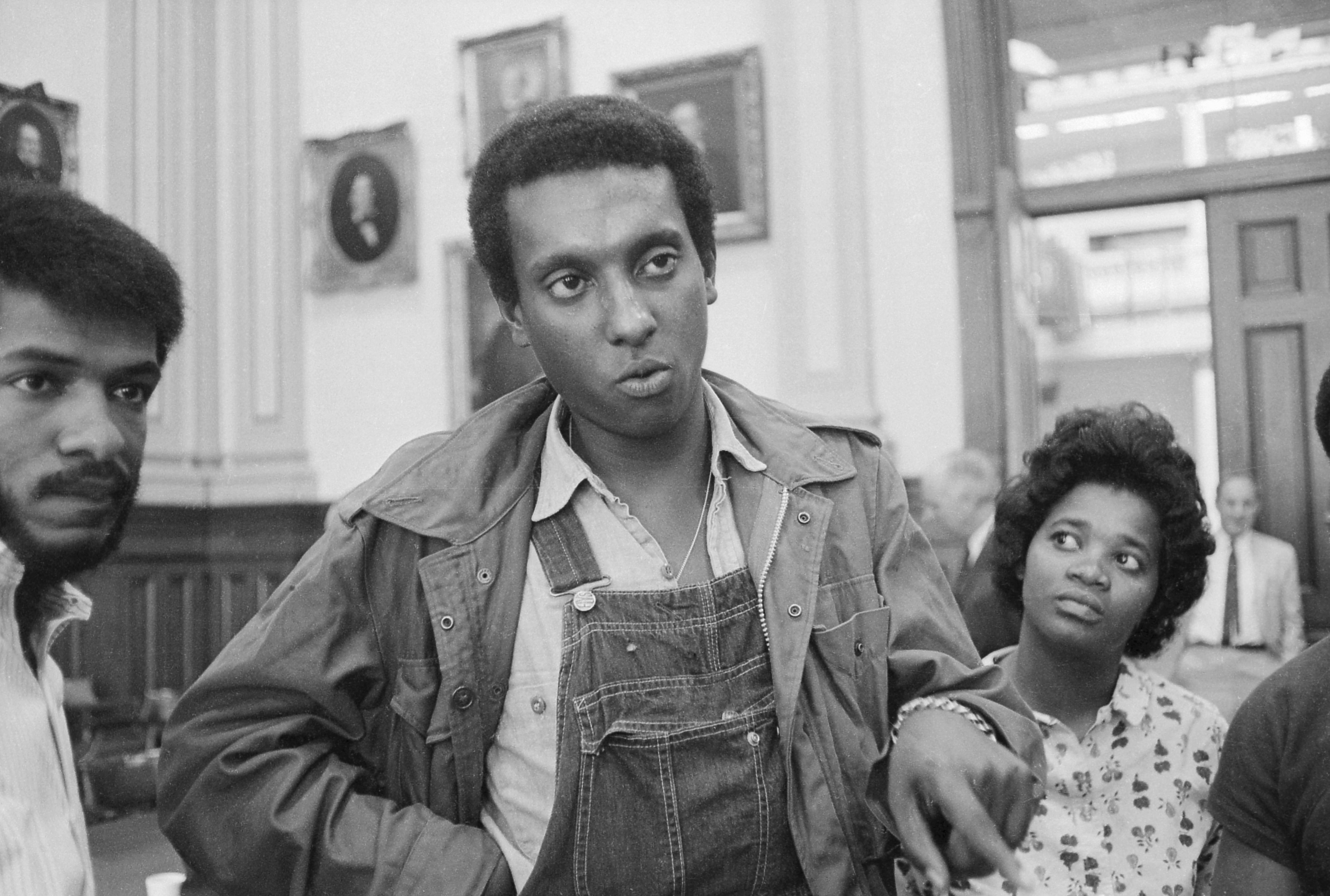(Original Caption) 5/23/66-Atlanta, GA: Stokely Carmichael, Chairman of the Student Nonviolent Coordinating Committee (SNCC), and a leader in the "Black Panther" political party, said here 5/23 that SNCC would bring "poll watchers" from Watts and Chicago hot spots to observe elections in the deep south. Carmichael is shown here talking to members of the press at the House Rules Committee which denied Julian Bond his seat in the Georgia lawmaking body.