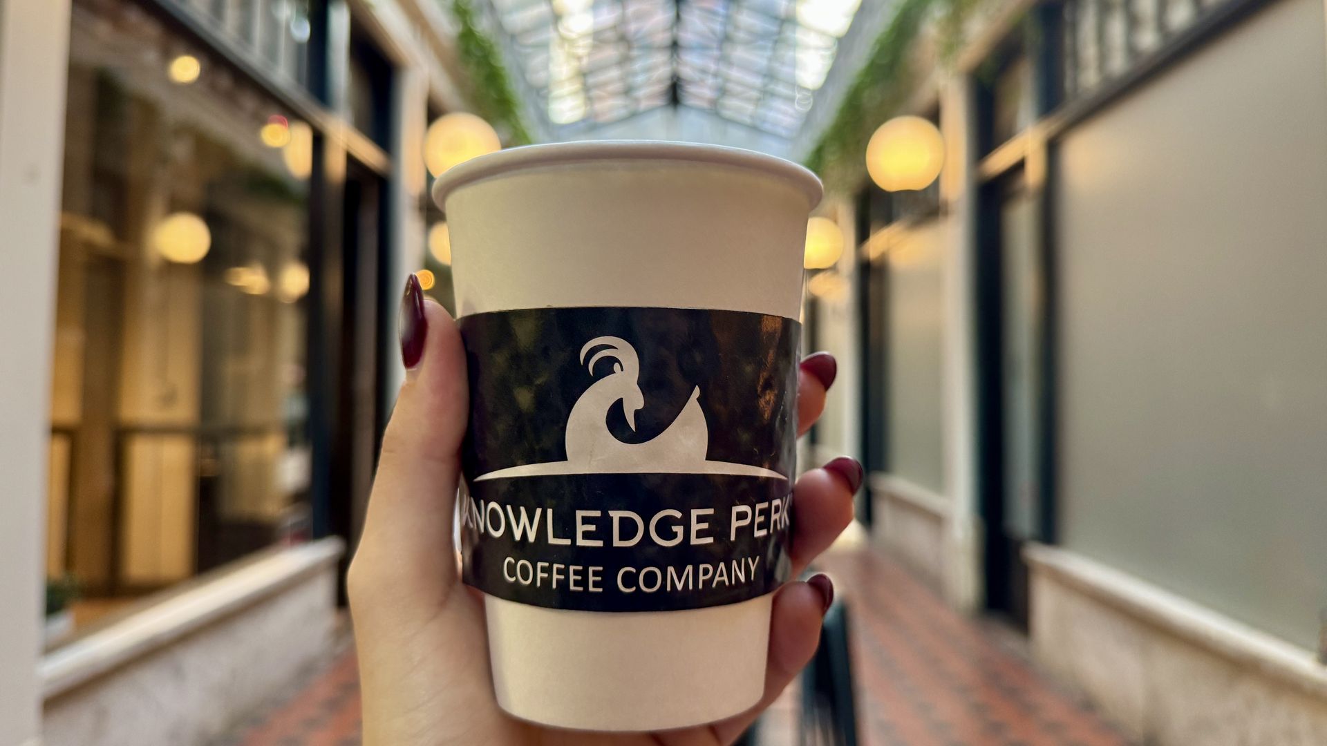 hand holding a coffee cup