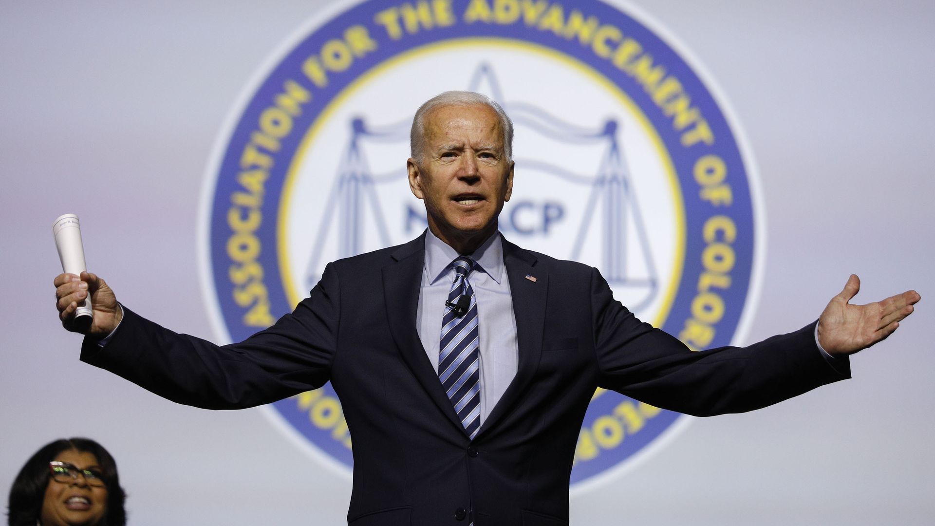 Photo of Joe Biden with his arms raised at the NAACP 110th National Convention in 2019