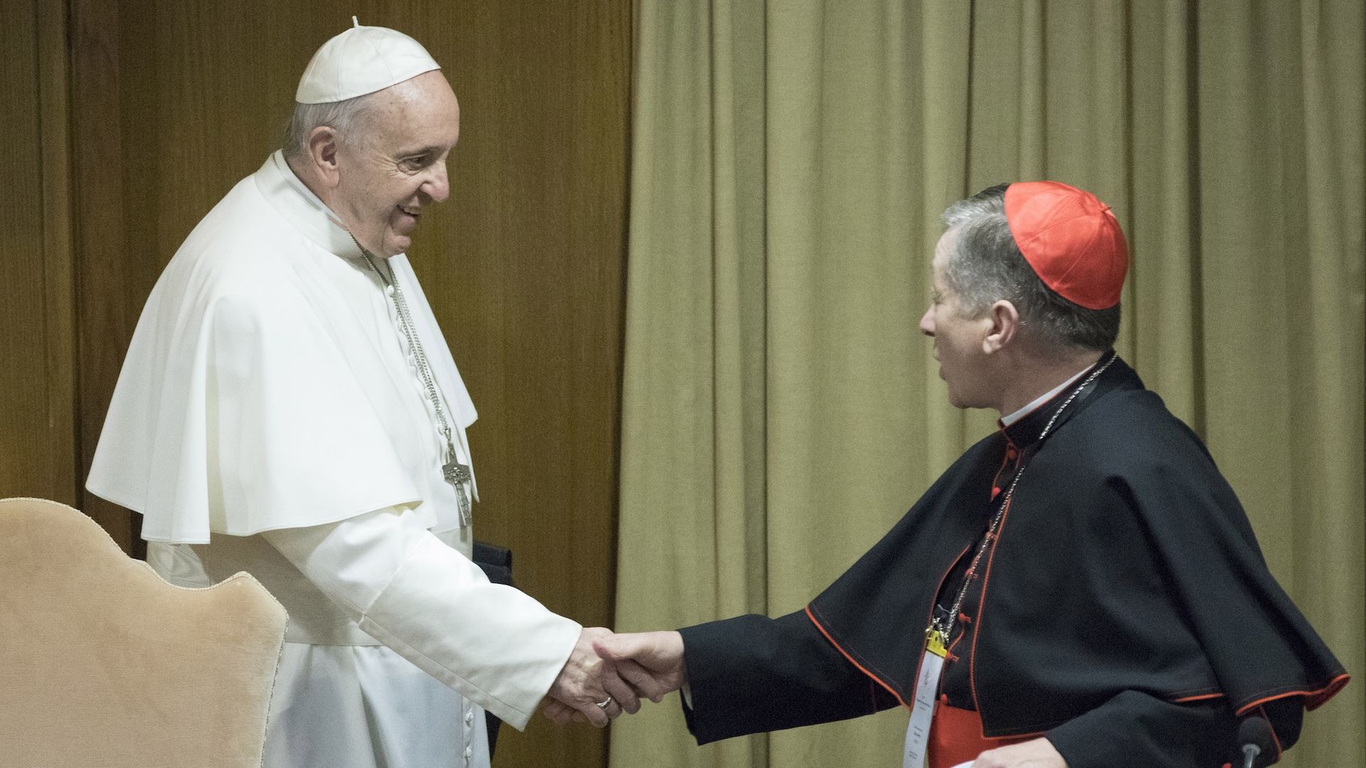 Pope Francis shaking hands with Cardinal Blase Cupich.