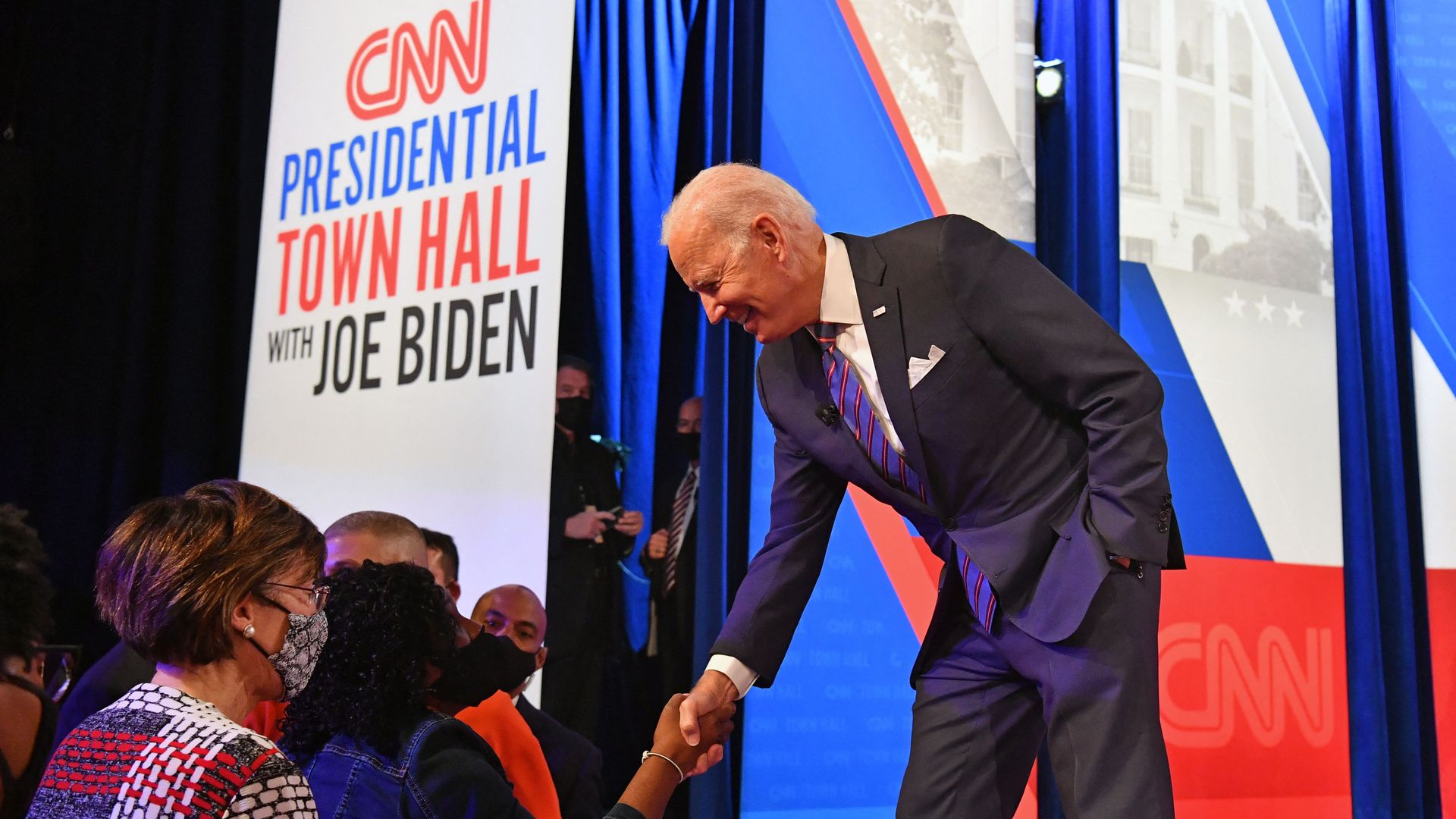 President Biden greets attendees during a commercial break in Baltimore last night.