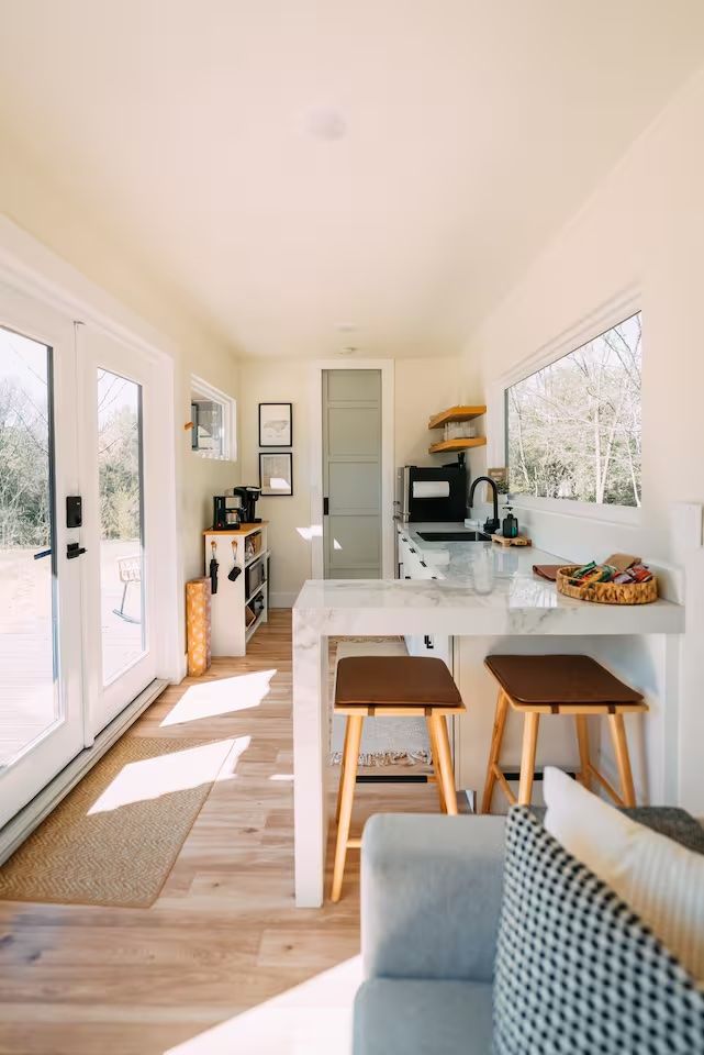 Kitchen in a storage container. Windows and glass doors allow natural light.