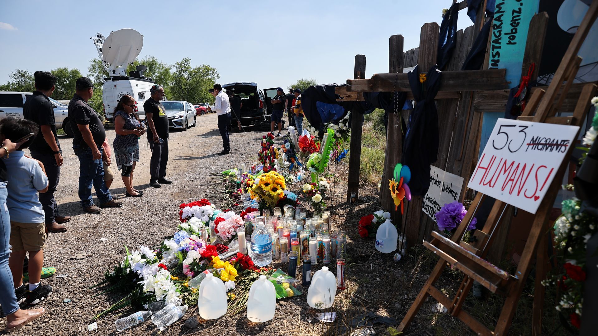  People ommemorate as they leave flowers, candles and water, where dozens of dead migrants found in a truck in San Antonio, Texas, United States on June 29.