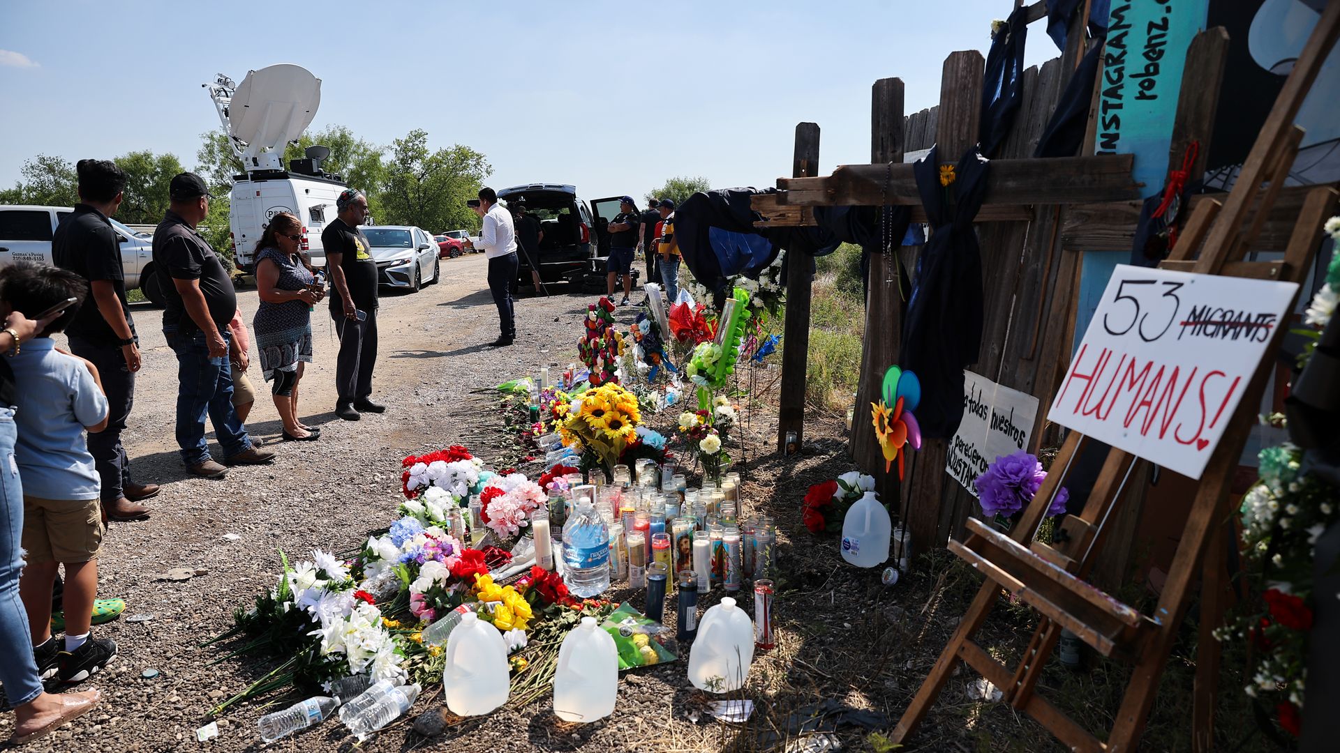 People ommemorate as they leave flowers, candles and water, where dozens of dead migrants found in a truck in San Antonio, Texas, United States on June 29.