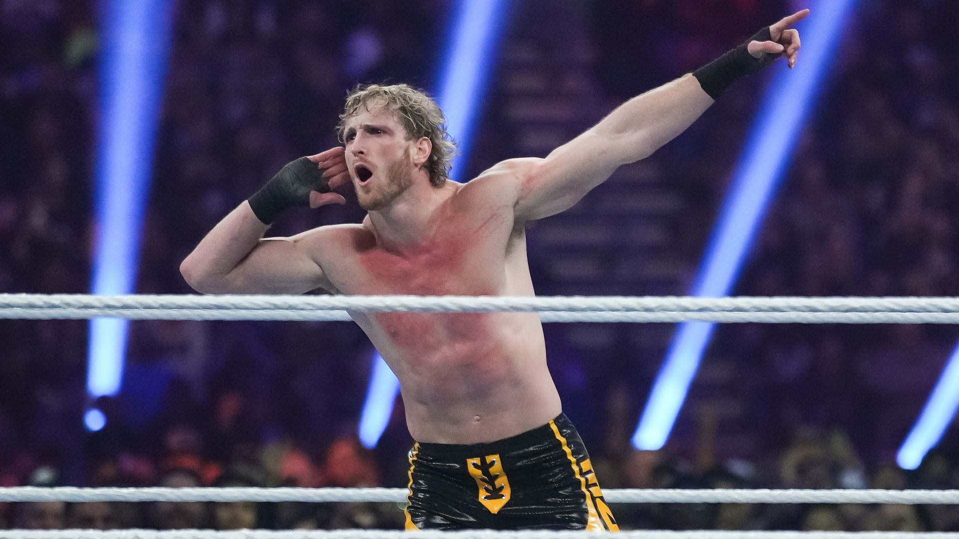 Logan Paul taunts fans inside a WWE ring. 