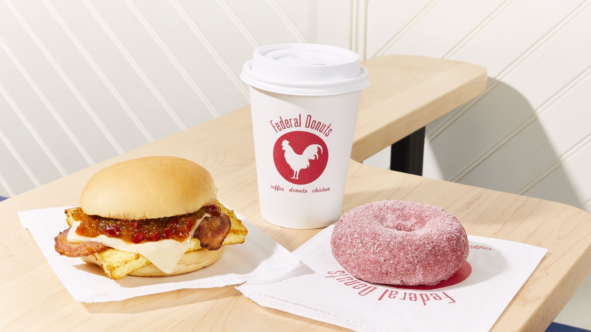 A fried chicken sandwich, coffee, and doughnut