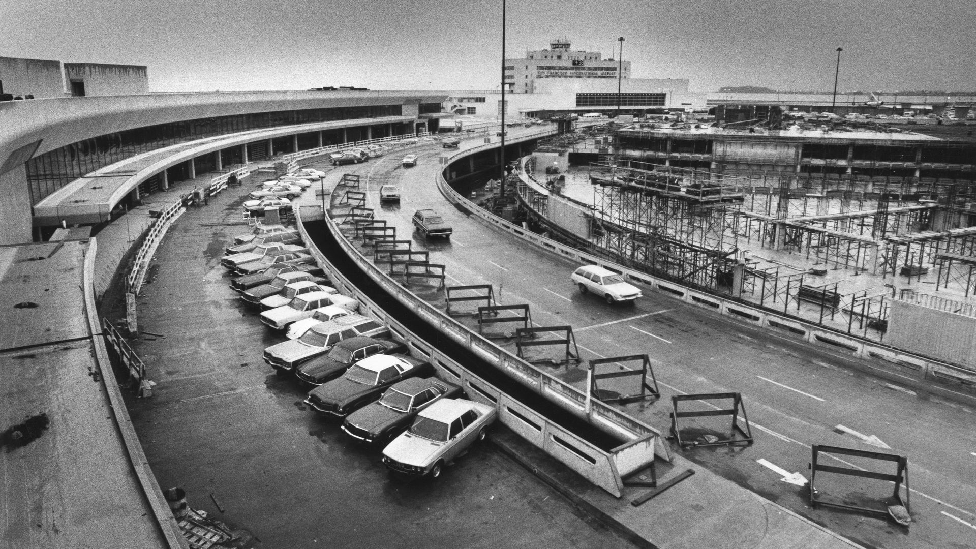Black and white photo of a construction site with wooden frames and columns