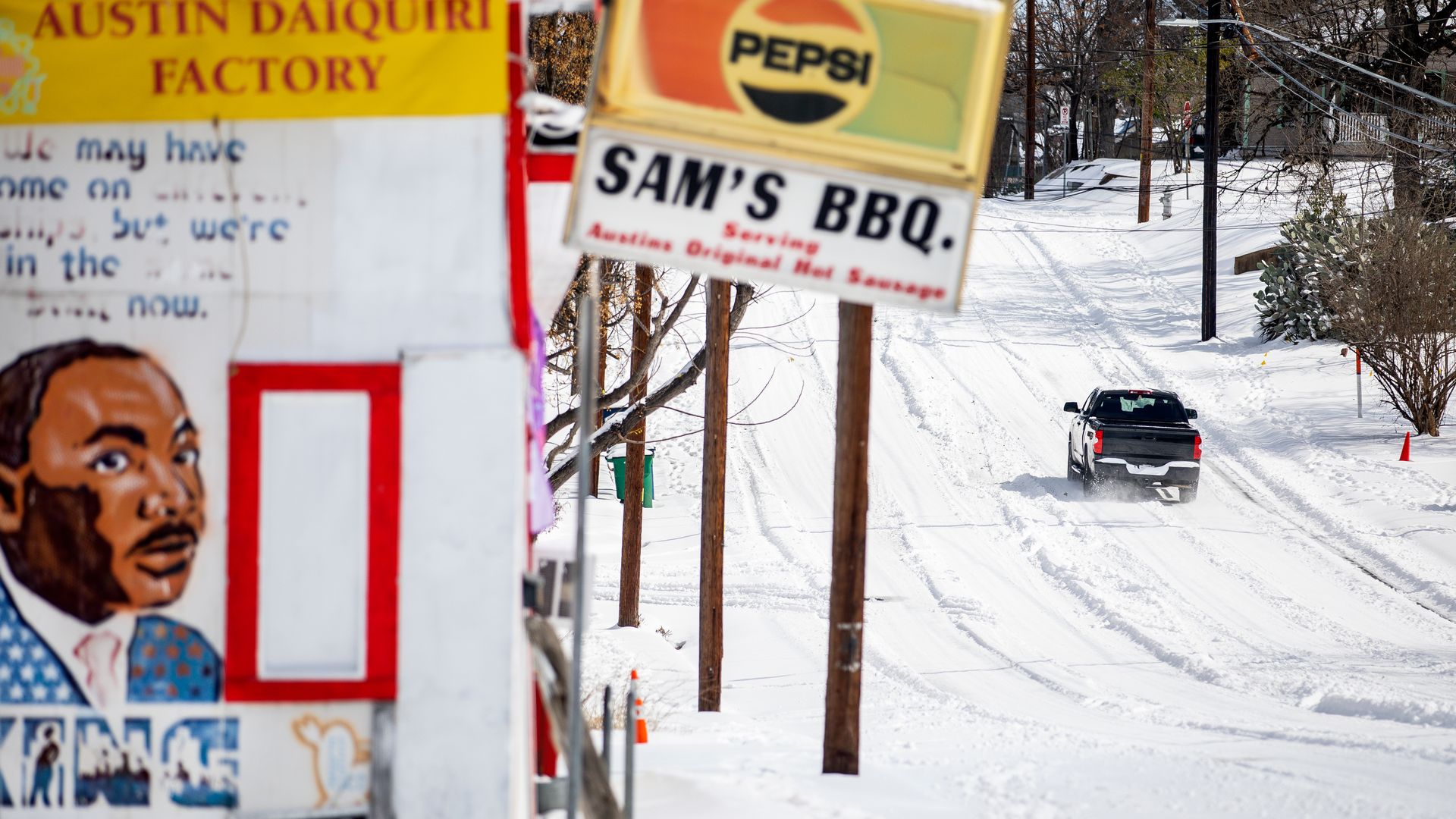 A truck drives up a frozen road in East Austin.