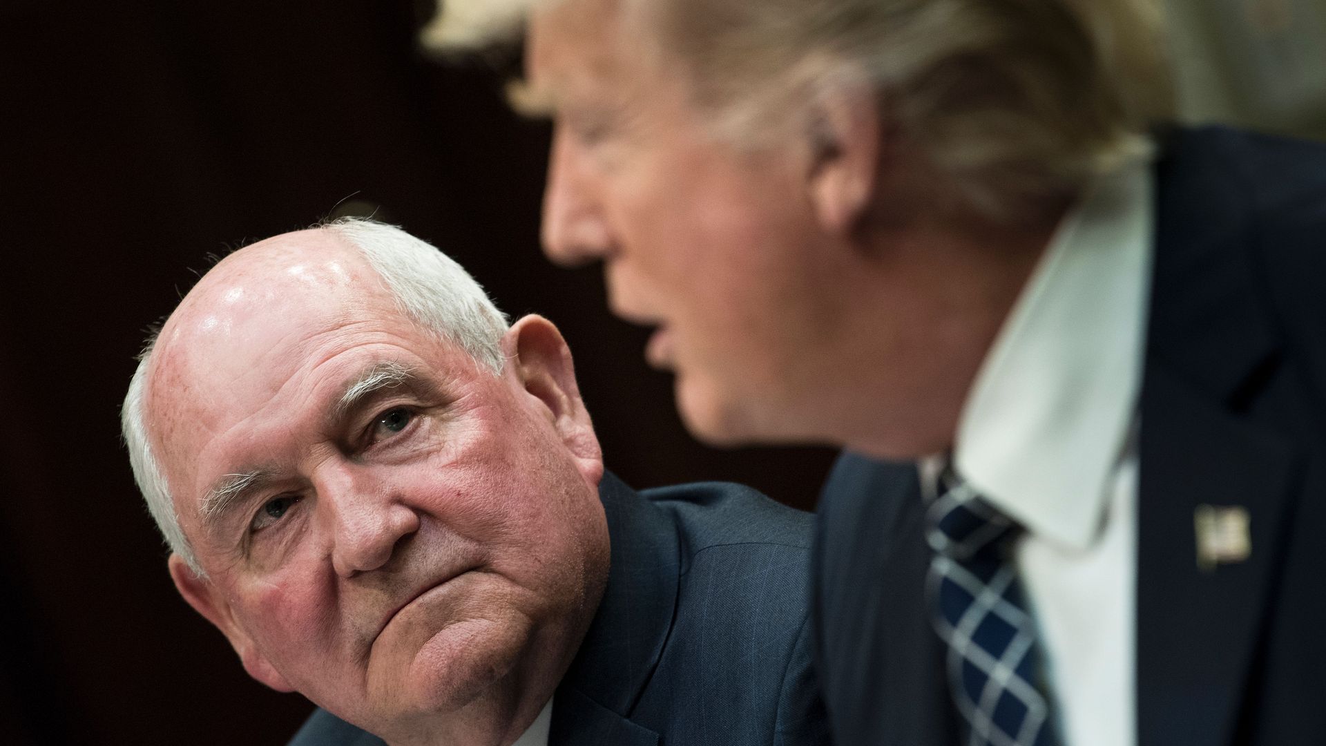 Sonny Perdue looks at Trump with a concerned look.