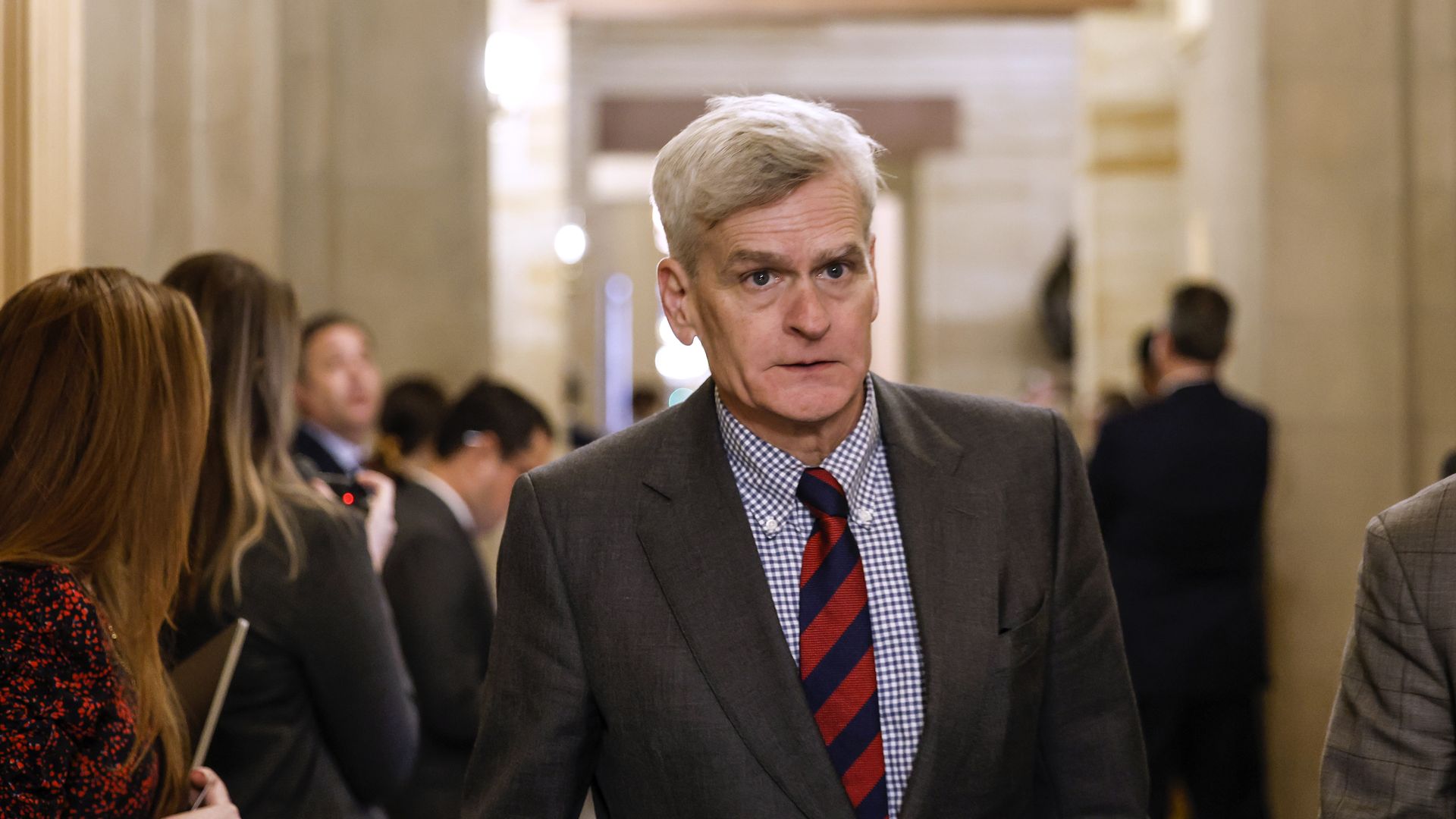 Senator Bill Cassidy walks through a hallway at the Capitol