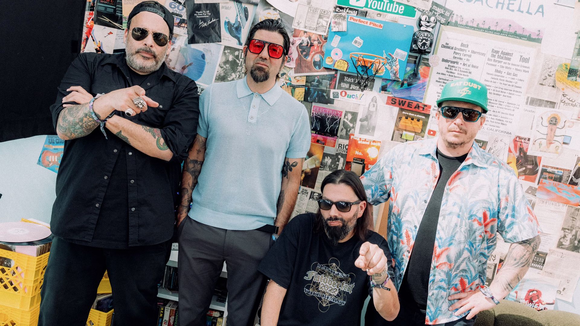 A group of men, all wearing sunglasses, pose for a photo. 