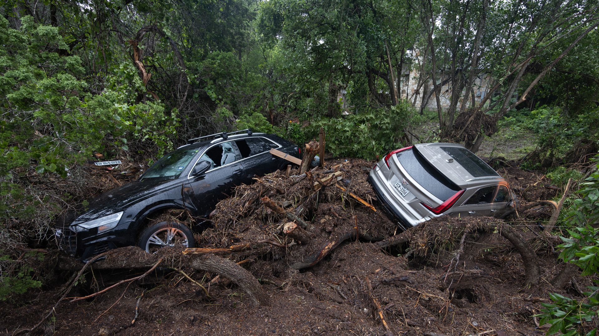 Two destroyed cars are lodged in fallen trees after  a deadly flash flood caused the Guadalupe River to rise 26 feet in less than an hour early Friday morning. Photo: Reginald Mathalone/NurPhoto via Getty Images