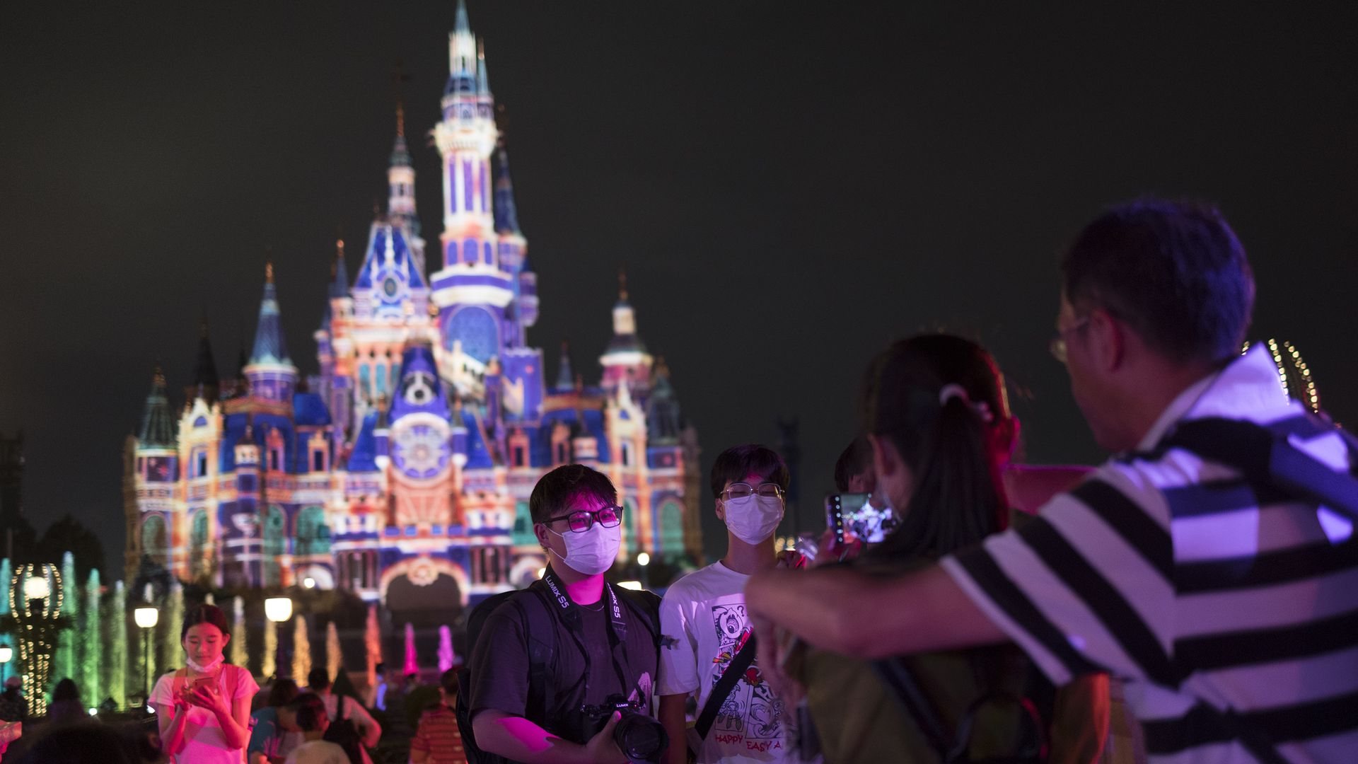 People pose for photo infront of the Enchanted Storybook Castle at Shanghai Disneyland.