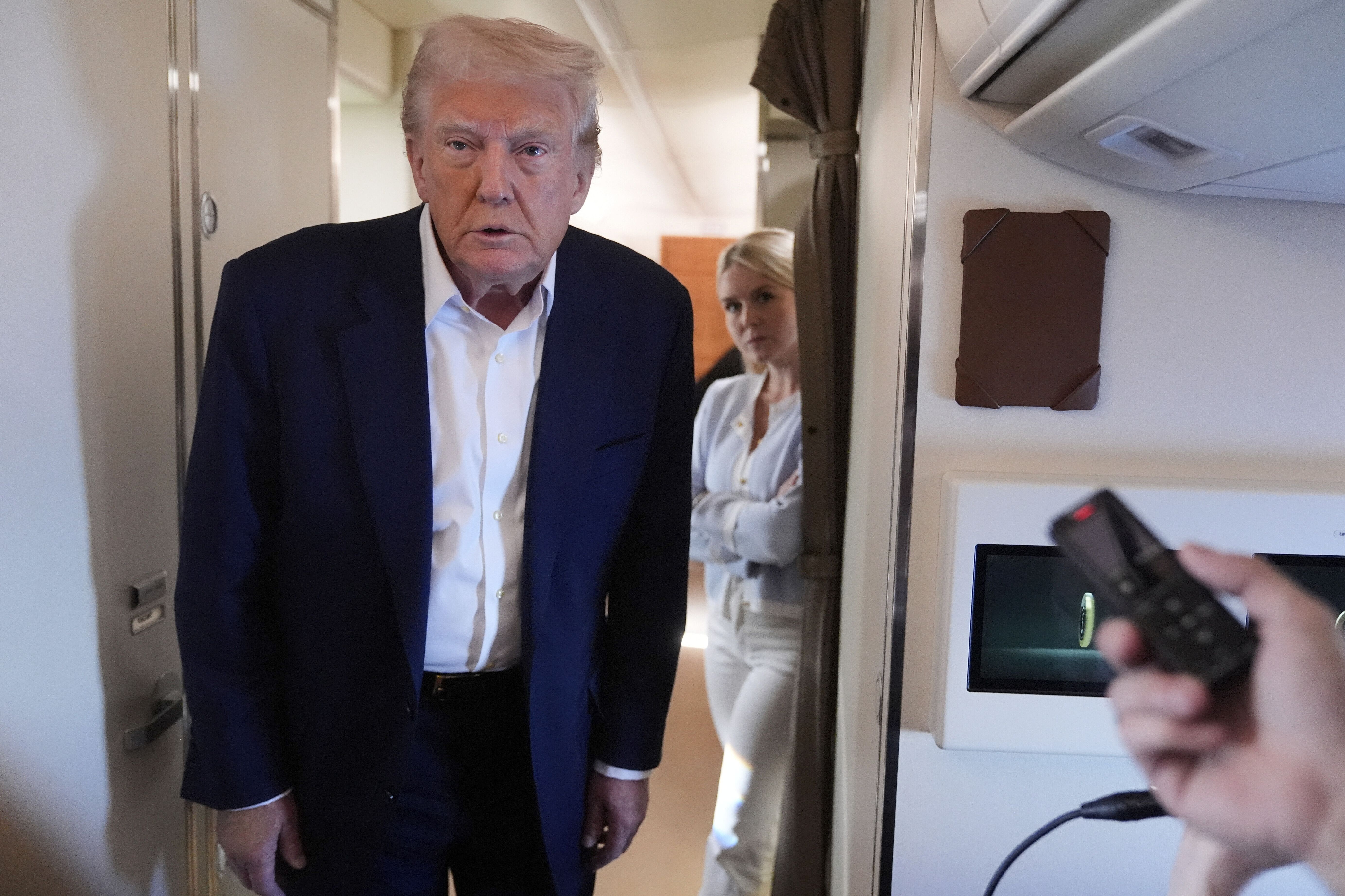 President Donald Trump talks with reporters on Air Force One as he heads back to Washington, Sunday, May 4, 2025, from West Palm Beach, Fla. (AP Photo/Manuel Balce Ceneta)