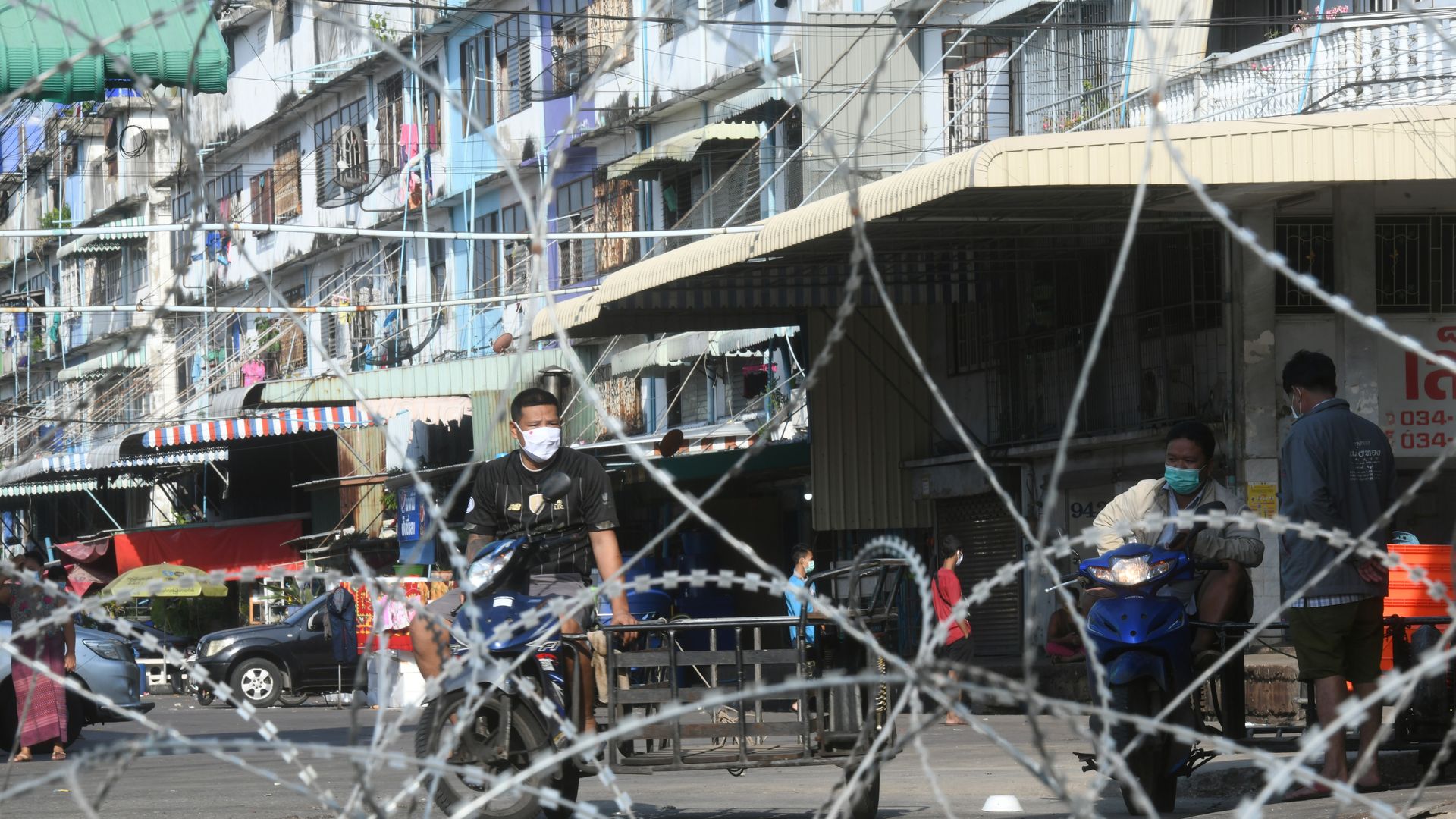 People are seen in the lockdown area near a seafood market in Samut Sakhon, Thailand, Dec. 20