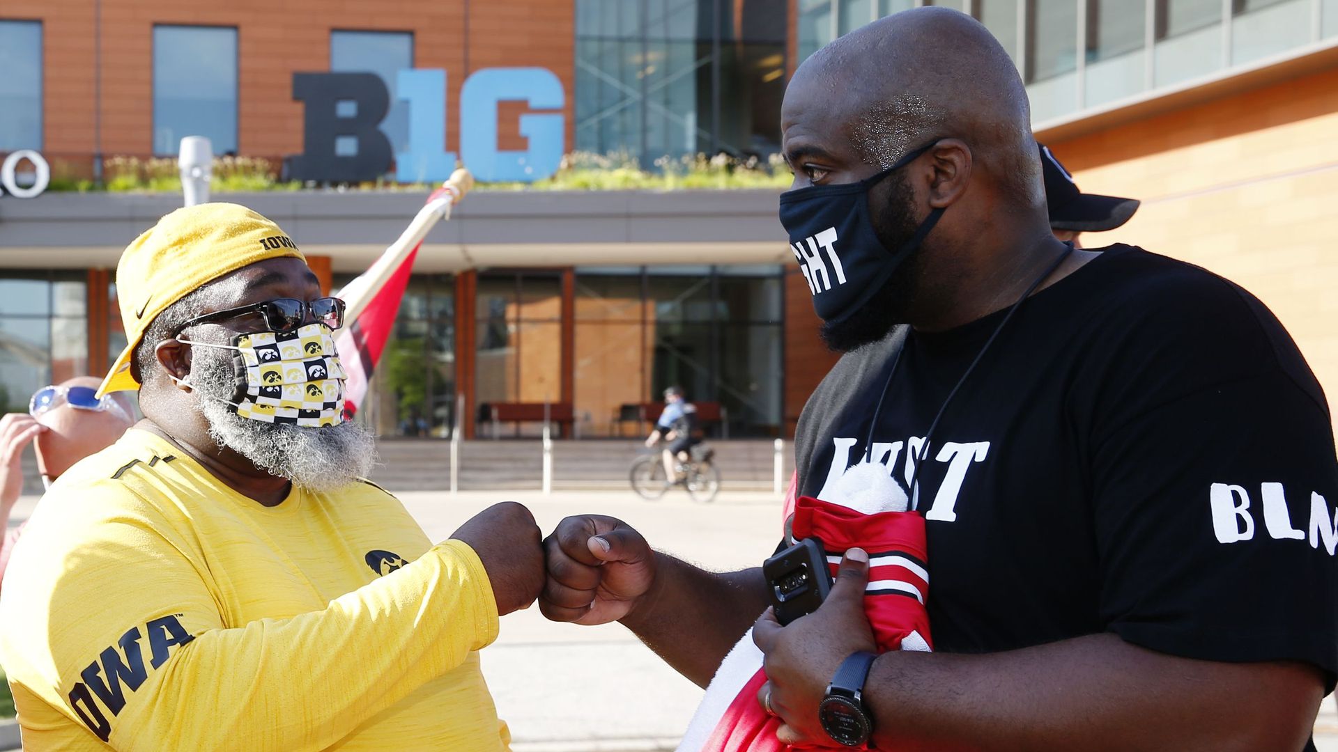 Rodney Dixon, a University of Iowa football dad (left), and Randy White, an Ohio State dad, during a parents' protest outside Big Ten HQ in Rosemont, Ill., on Aug. 21.