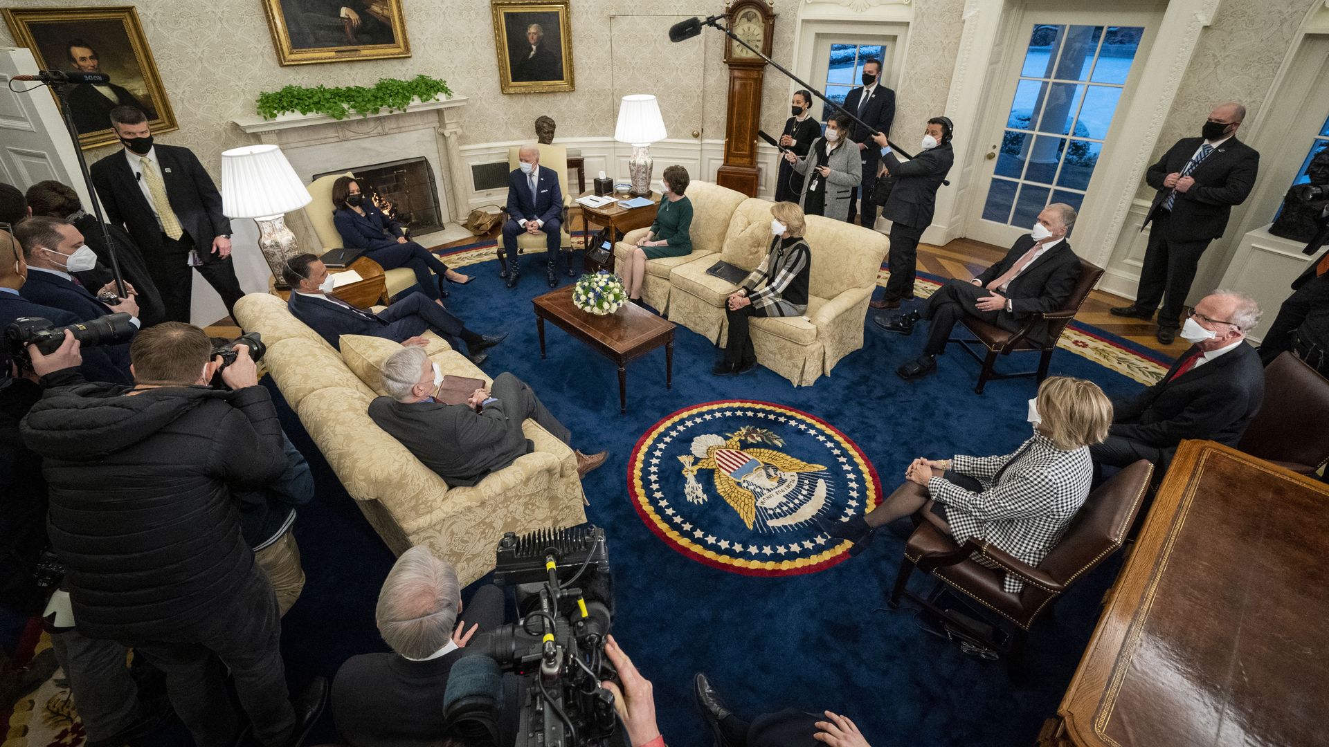 President Biden and Vice President Kamala Harris are seen meeting with a bipartisan group of senators.