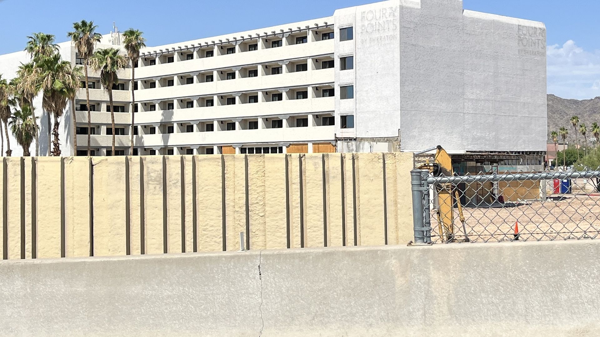 A hotel building with a fence around it. 