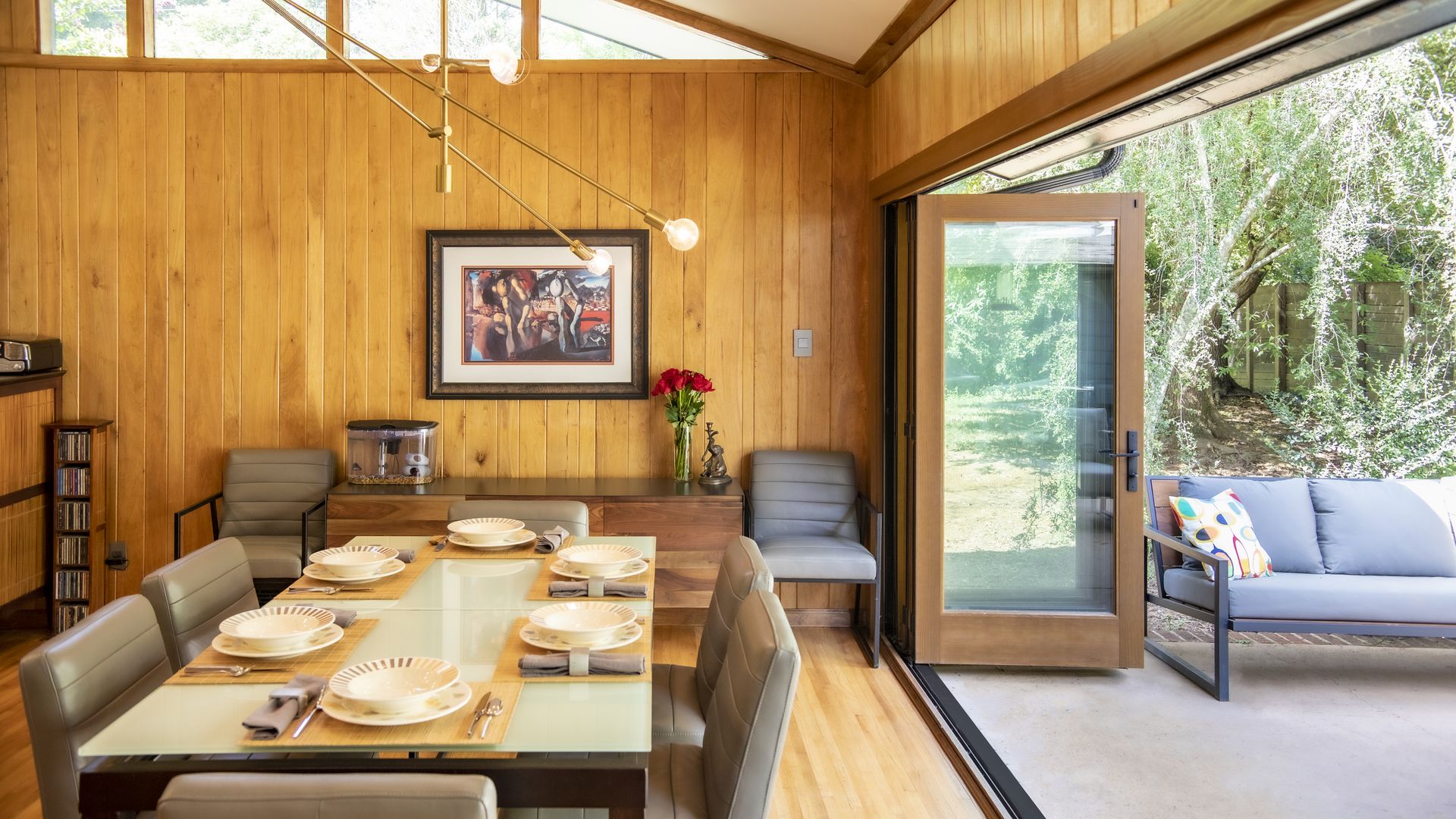 Dining room inside a modern home, with wood paneled interiors and vaulted ceiling