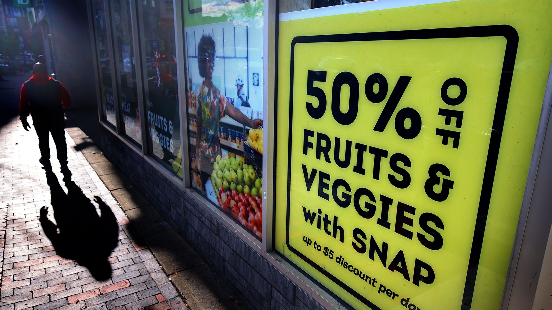 A closed Daily Table Community Grocery Store in Nubian Square, Boston, with signs advertising SNAP benefits still visible in the windows.