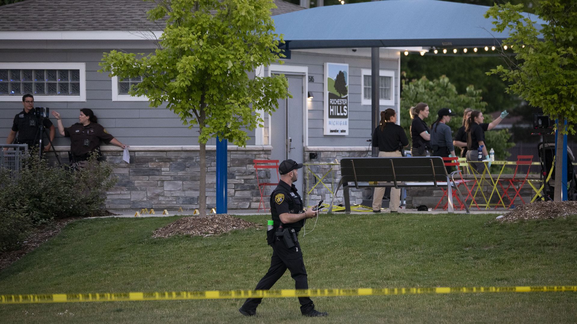 Police investigate the scene at the Brooklands Plaza Splash Pad on Saturday.