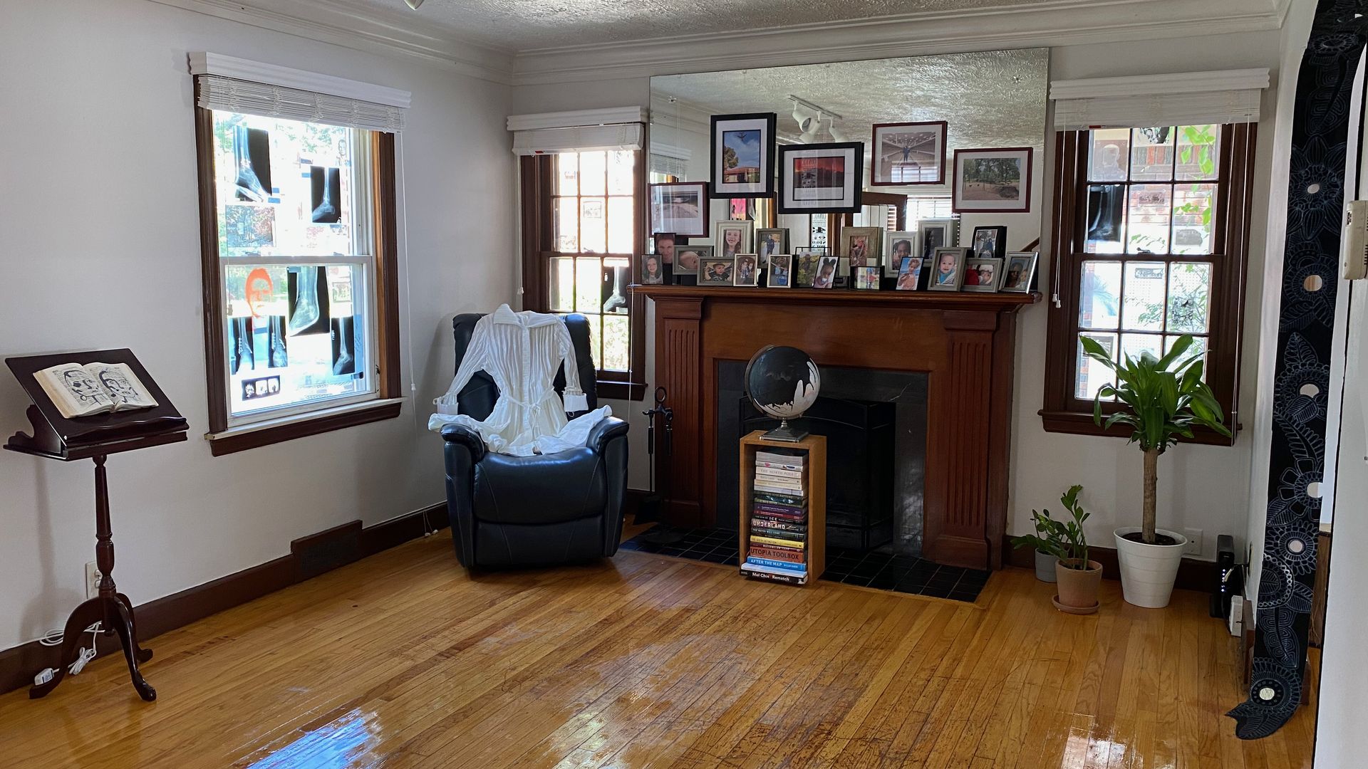 Art pieces are shown in a house with wood flooring.