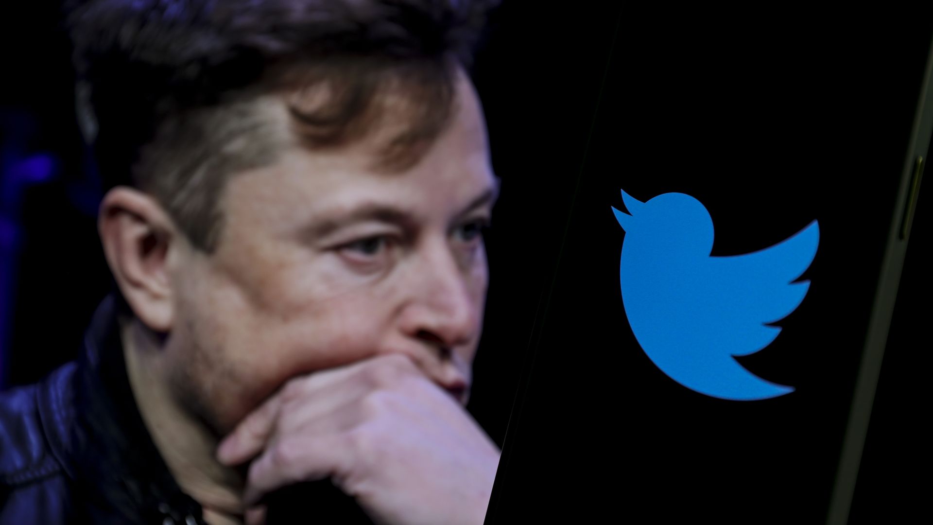 In this photo illustration, the image of Elon Musk is displayed on a computer screen and the logo of twitter on a mobile phone in Ankara, Turkiye on October 06, 2022.