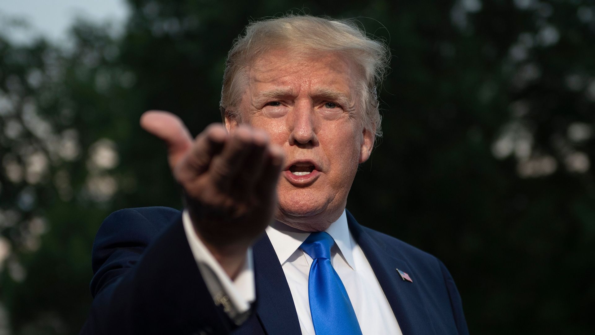 President Donald Trump speaks with reporters as he departs the White House, in Washington, DC