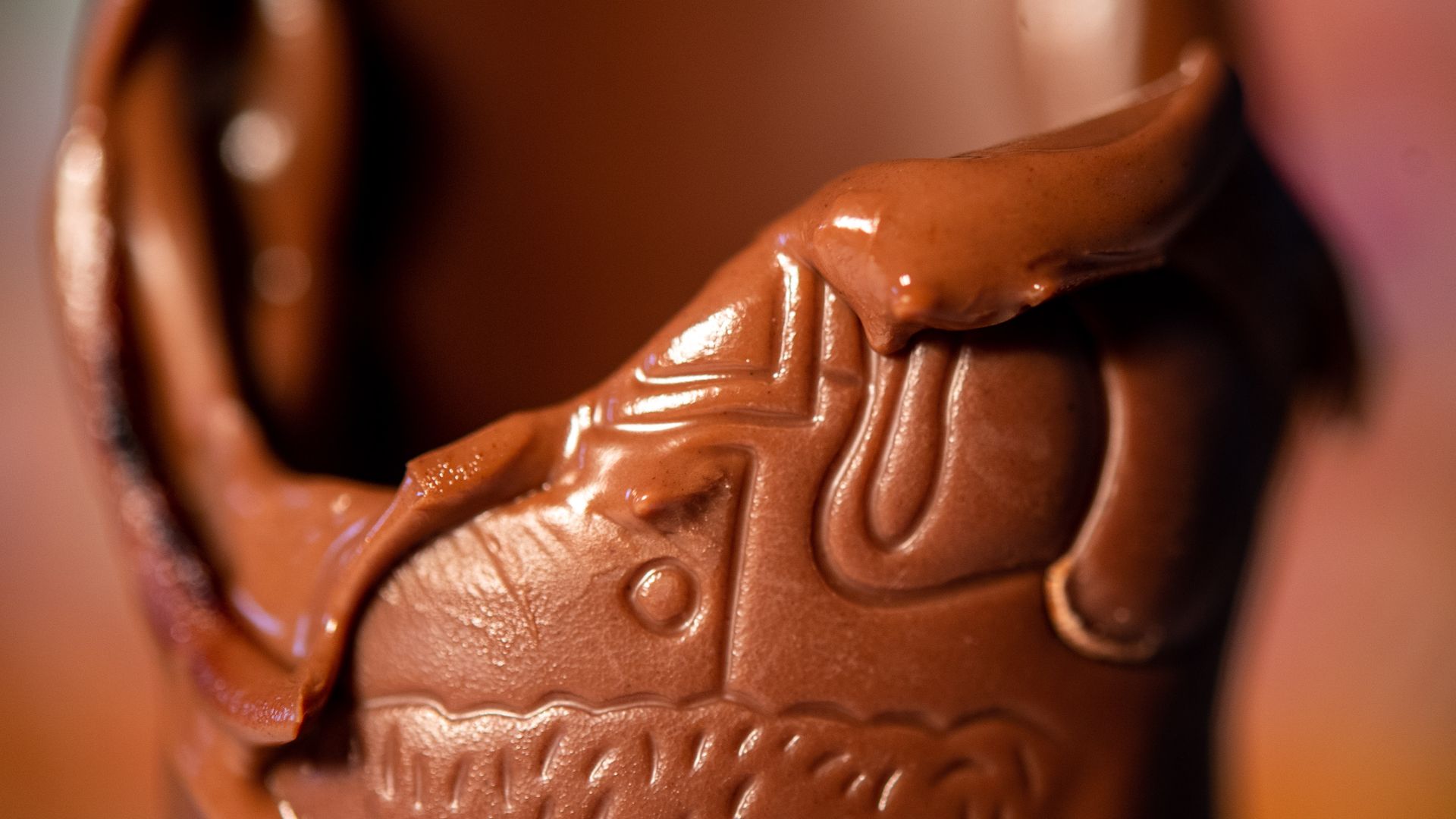 Up-close photo of a melted chocolate piccolo standing on a table.