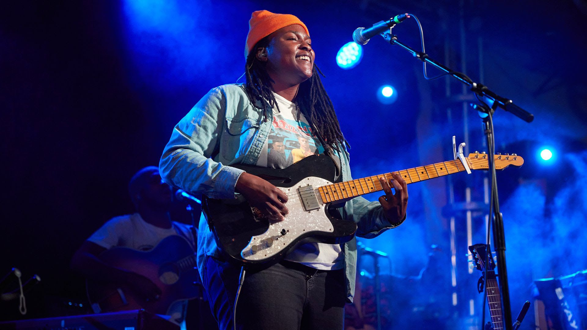 Joy Oladokun performs at 3rd and Lindsley in June, 2021 holding a guitar.