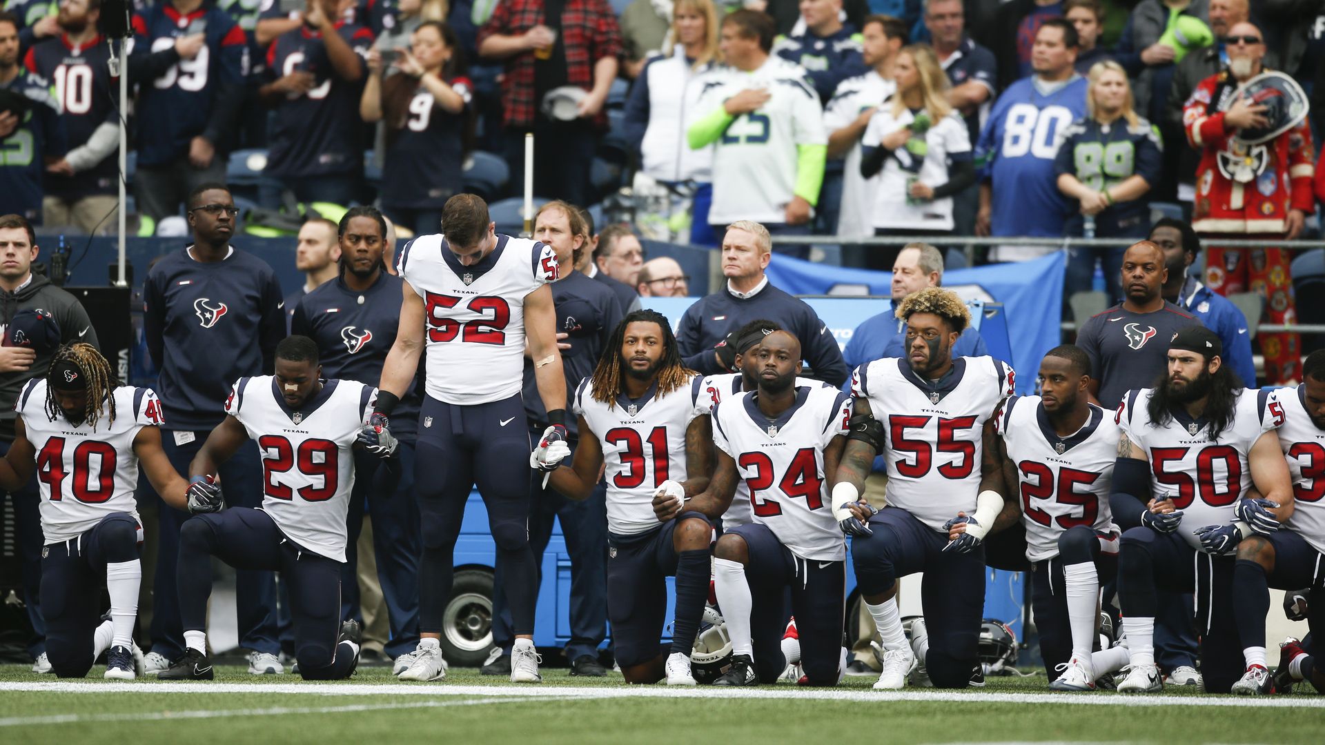Members of the Houston Texans kneel during the national anthem