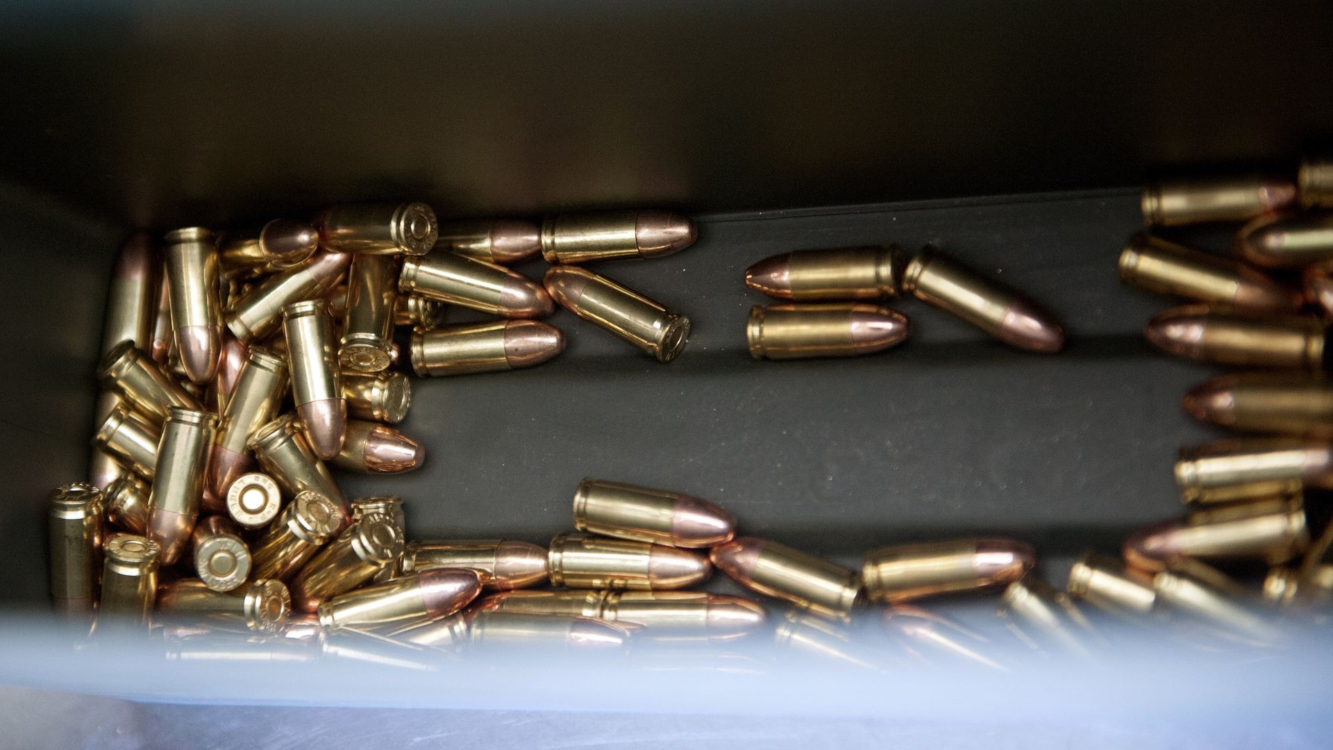 A photo of numerous brass bullets in a bin