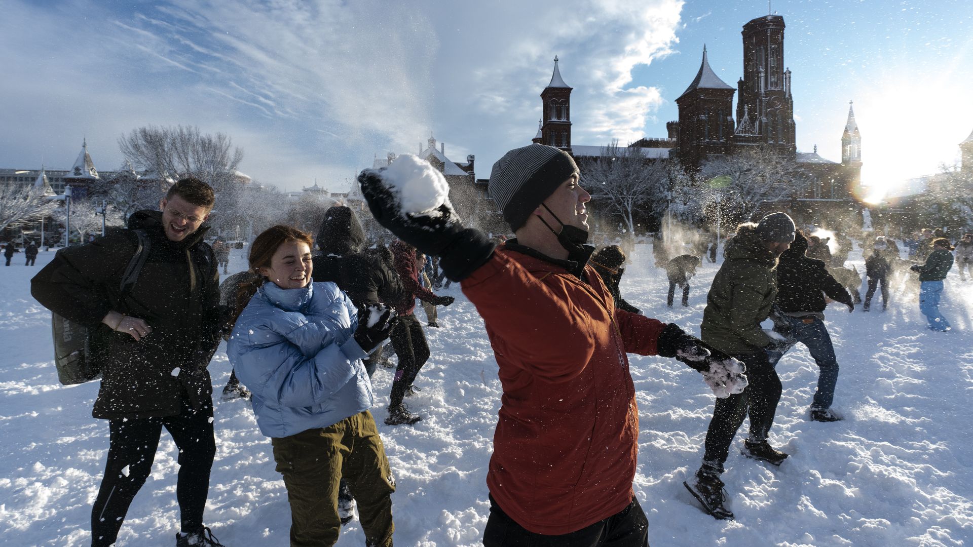 A man gets ready to throw a snowball at a snowball fight on the National Mall