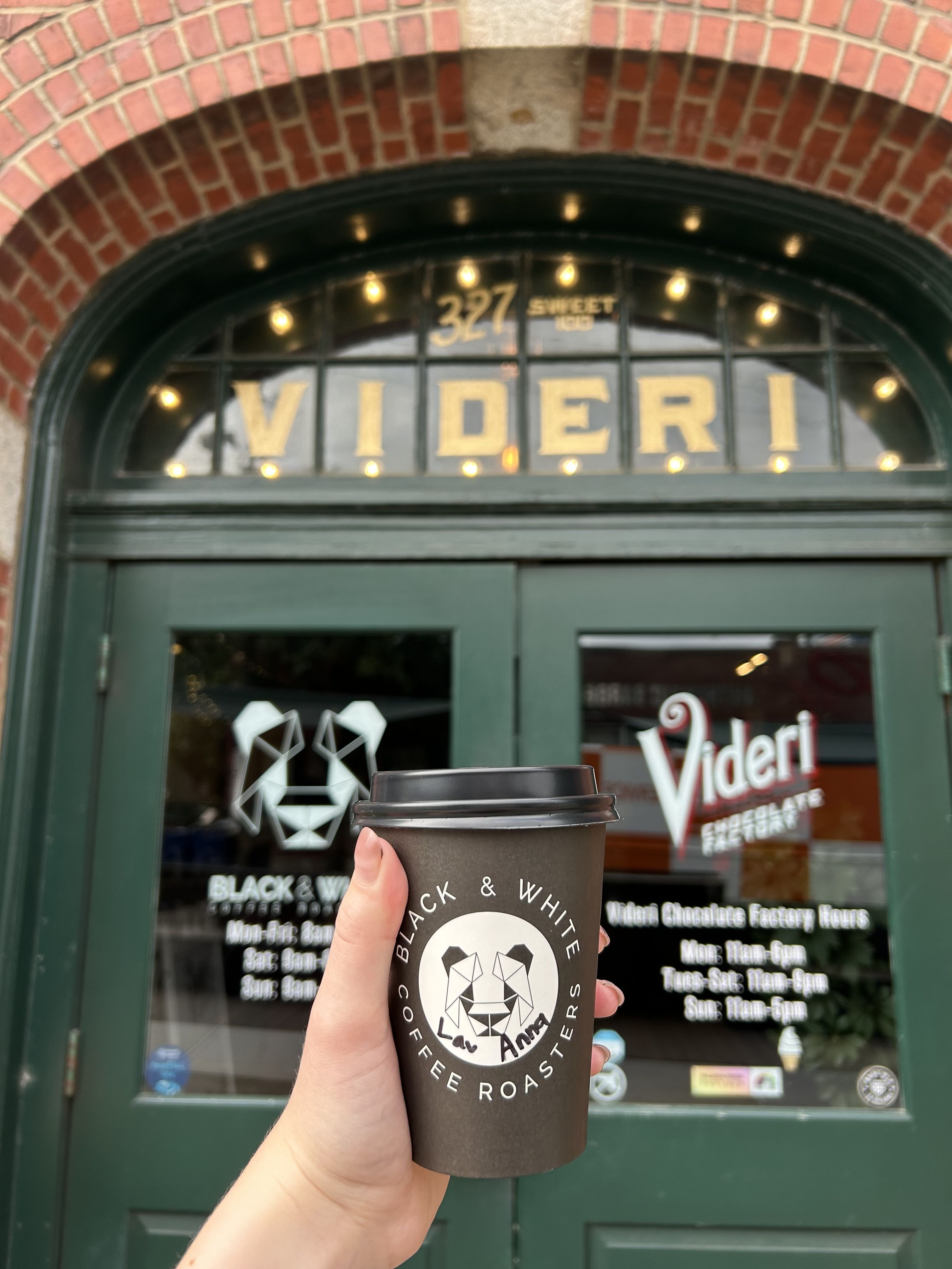 A cup of Black & White coffee outside its storefront