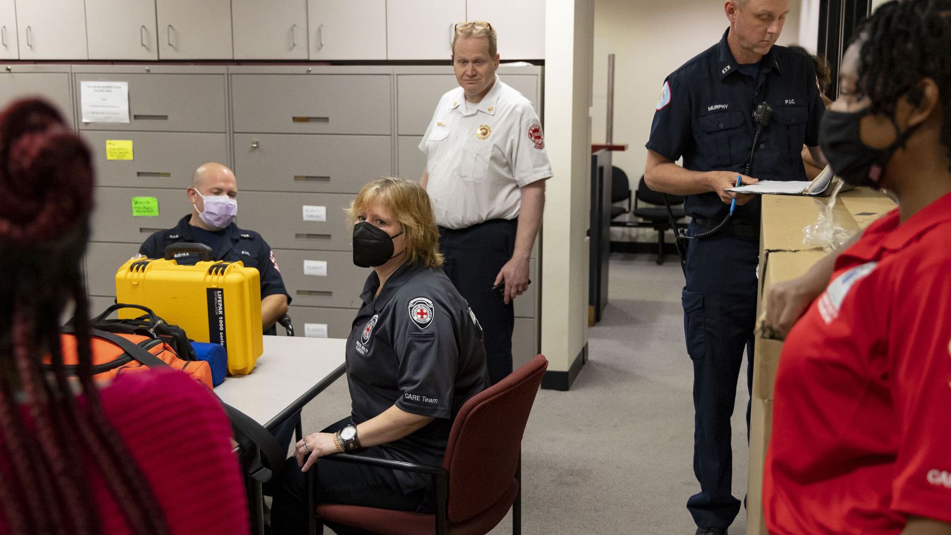 Photo of first responders sitting around a table. 