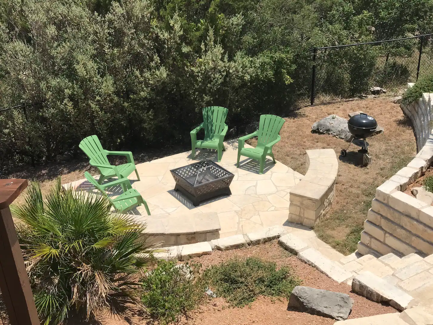 Chairs surround an outdoor fire pit