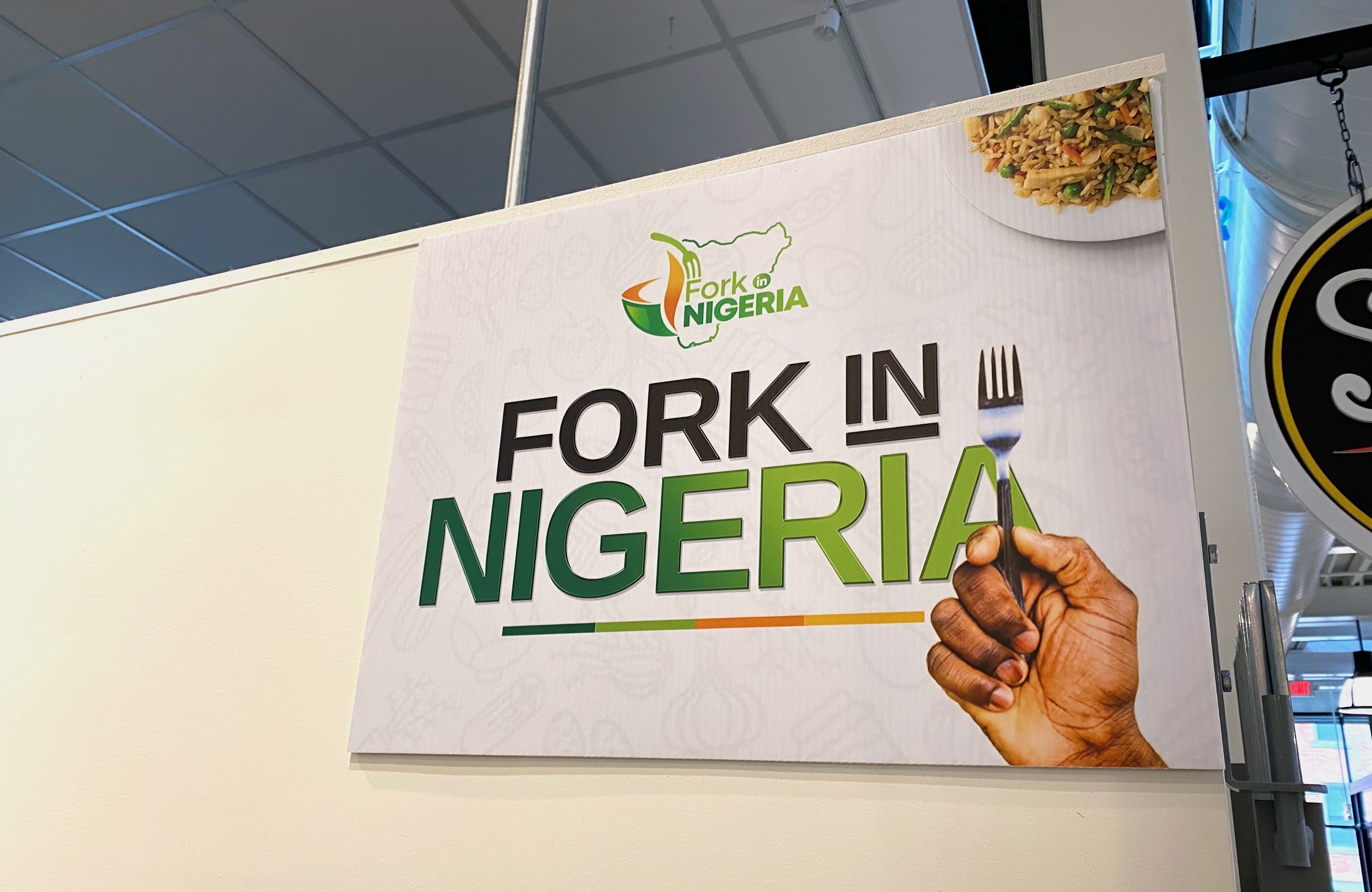 A sign reading "Fork in Nigeria" with a hand holding a fork