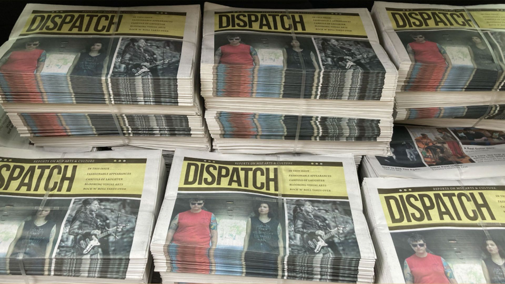 Six stacks of newspapers with the word DISPATCH on them.