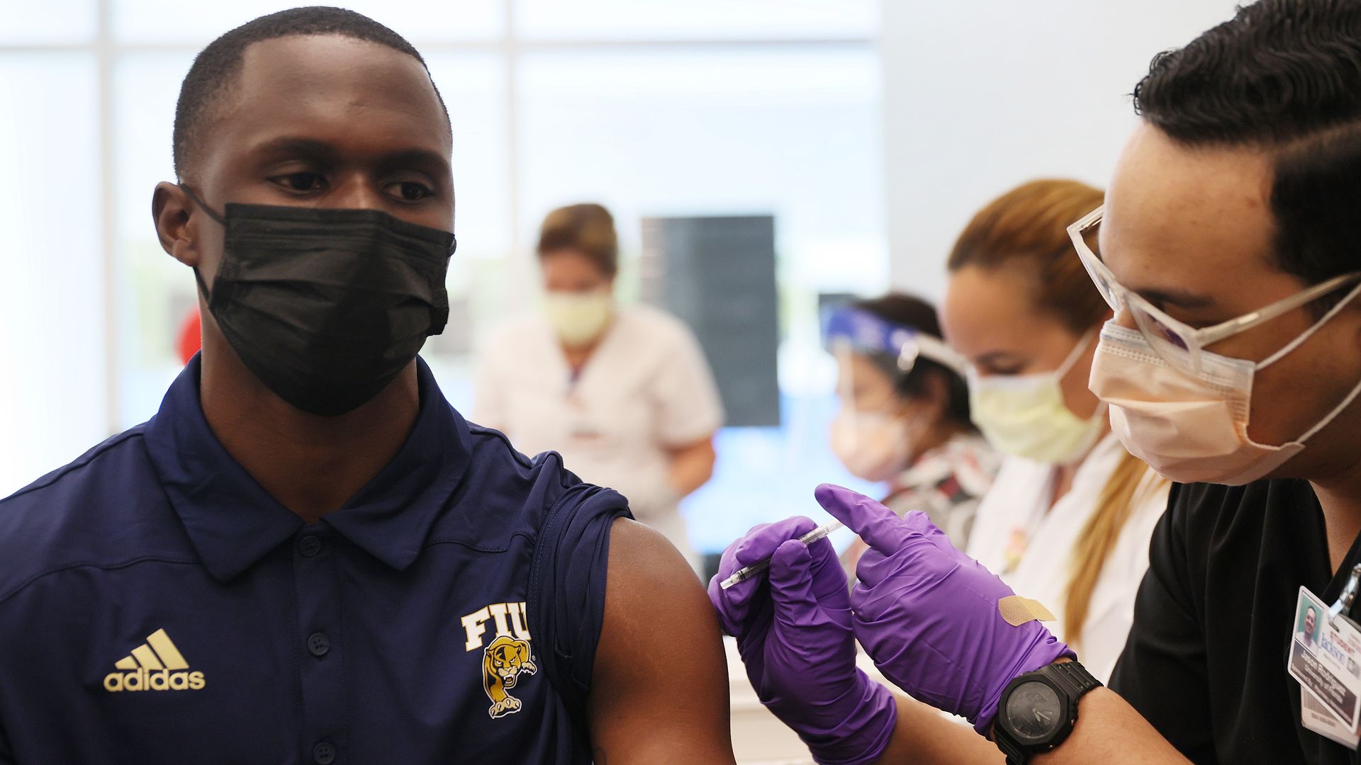 A pharmacy student administering a coronavirus vaccine to another student at Florida International University on April 15 in Miami.