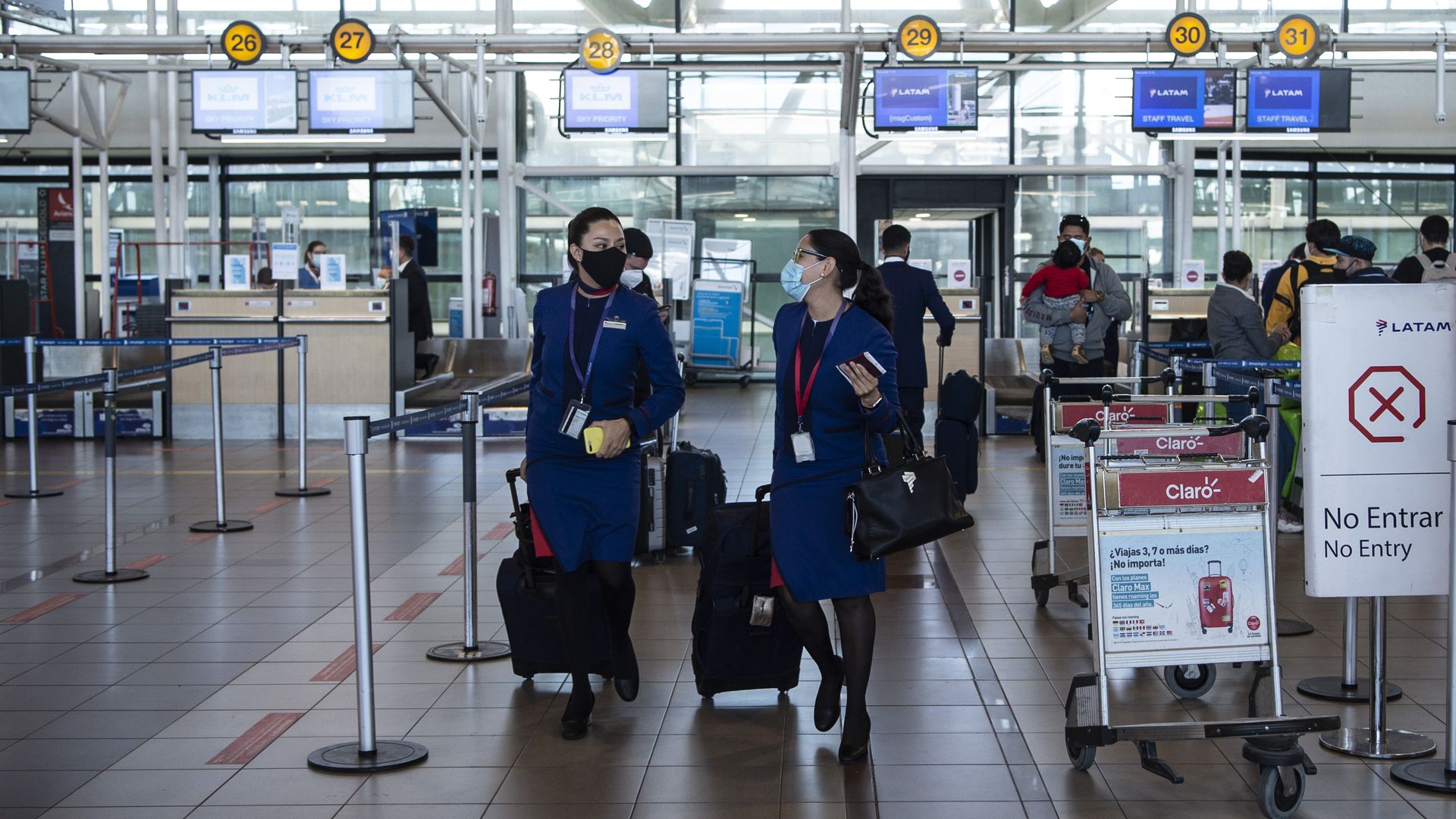 Airline employees are seen at Arturo Merino Benitez International Airport in Santiago on November 23