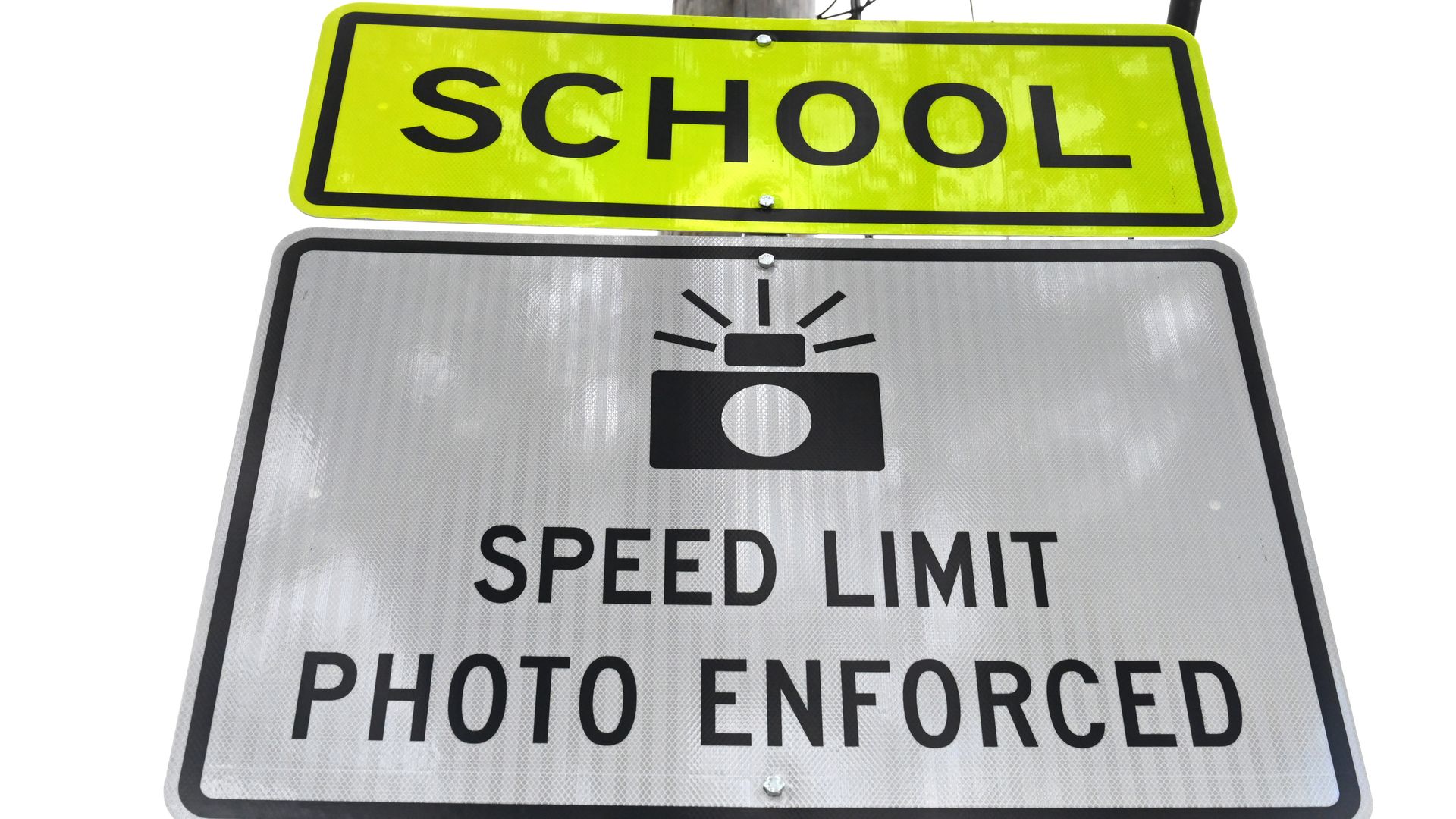 a speed limit photo enforced sign with a picture of a camera above it and the word "School"