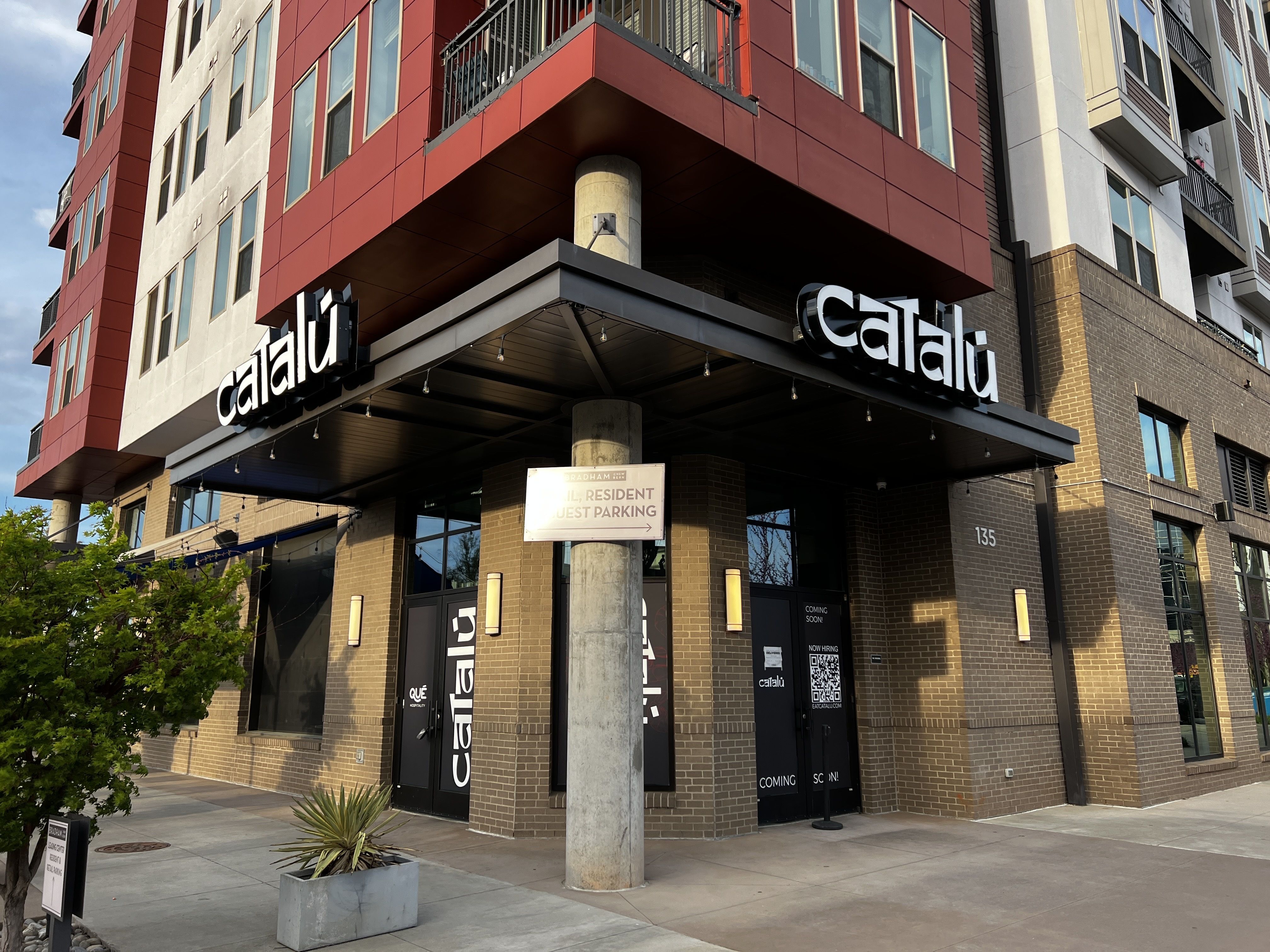 ground floor of apartment building with sign that reads "Catalu"