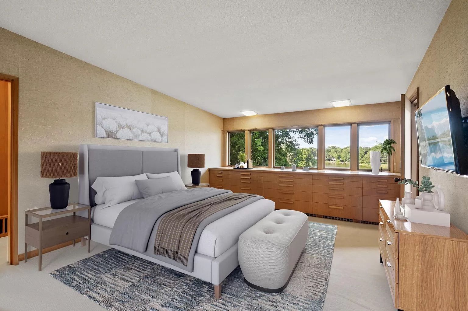 A bedroom with gray furniture and beige walls.