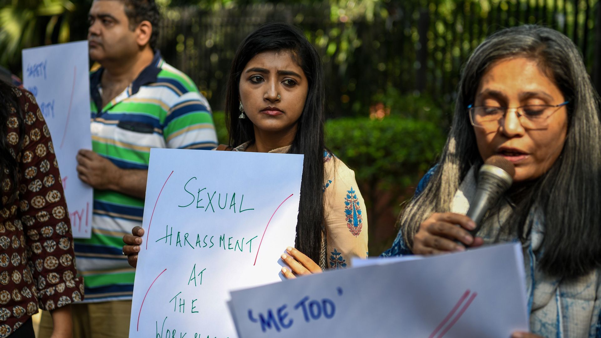 Women holding signs regarding sexual harassment and #MeToo